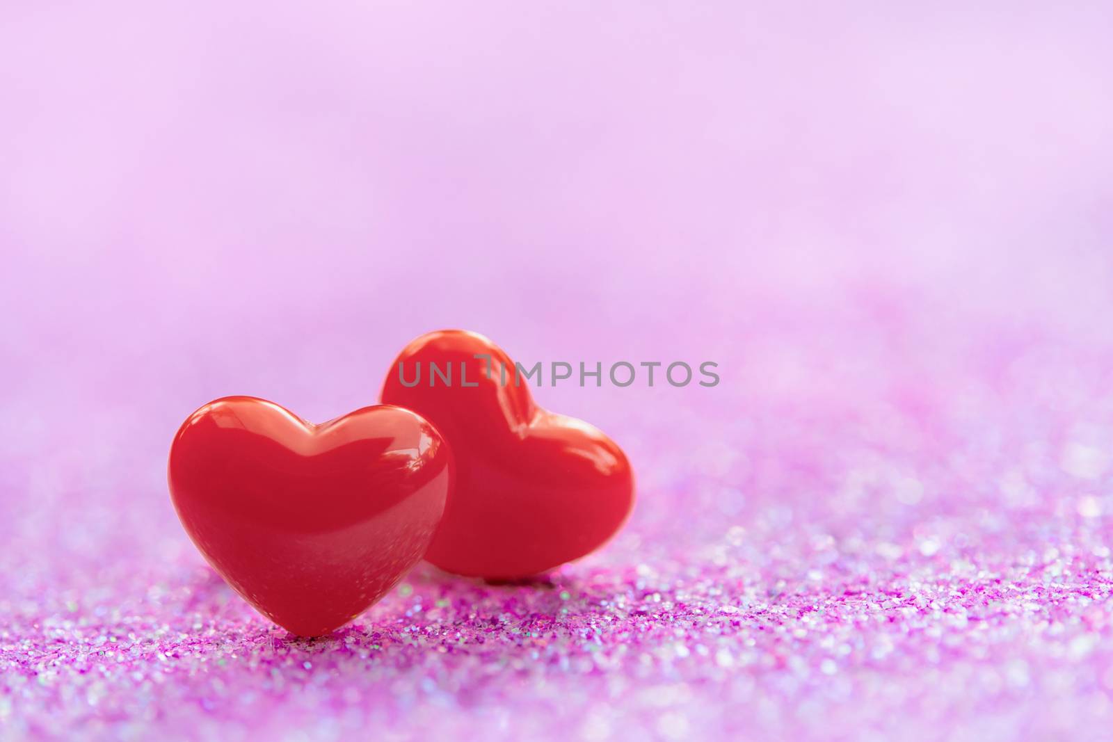 Valentines Day background with Red heart shapes on abstract light pink glitter background, Copy space