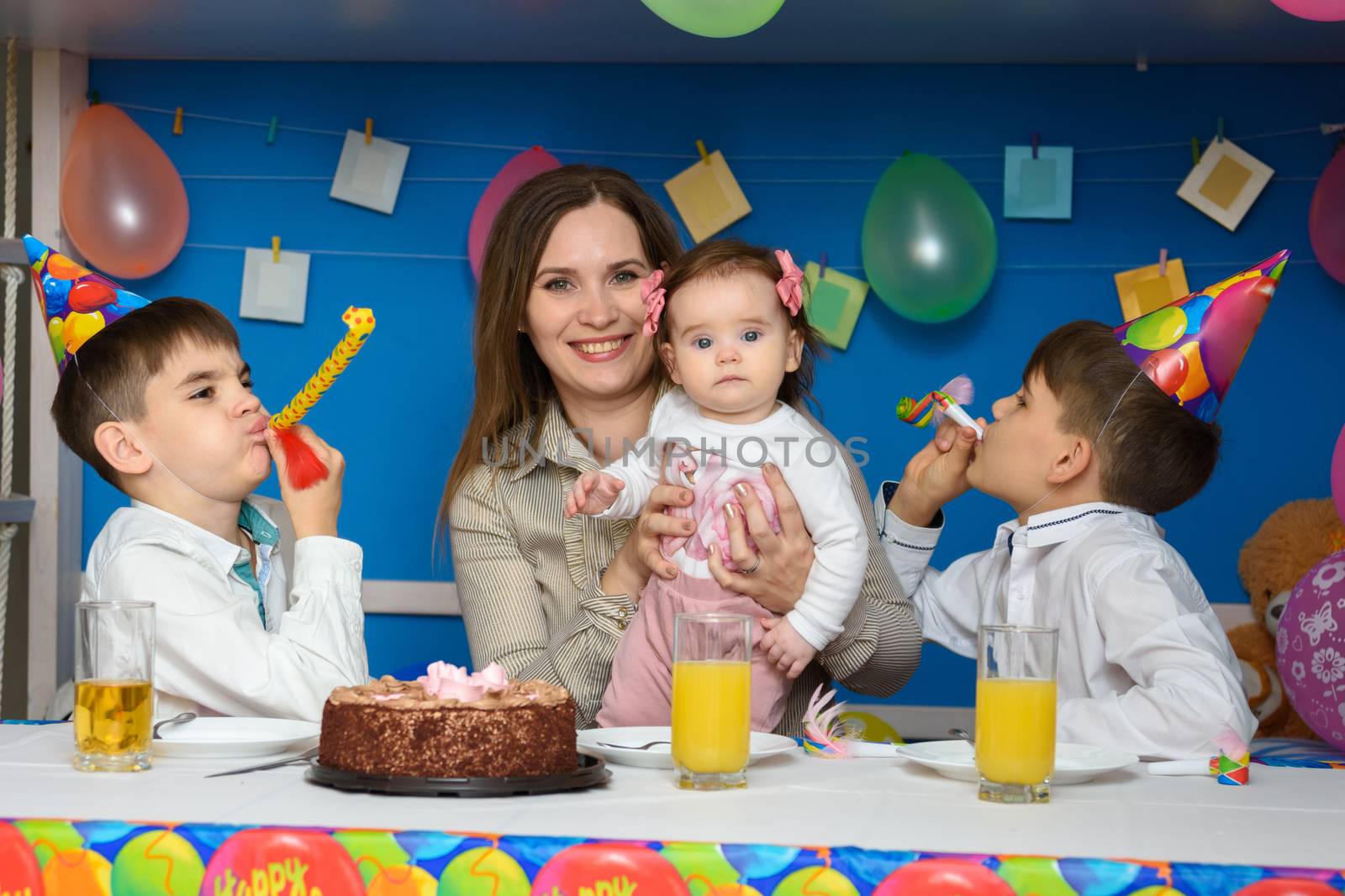 Children joyfully blow in the bells at a birthday party