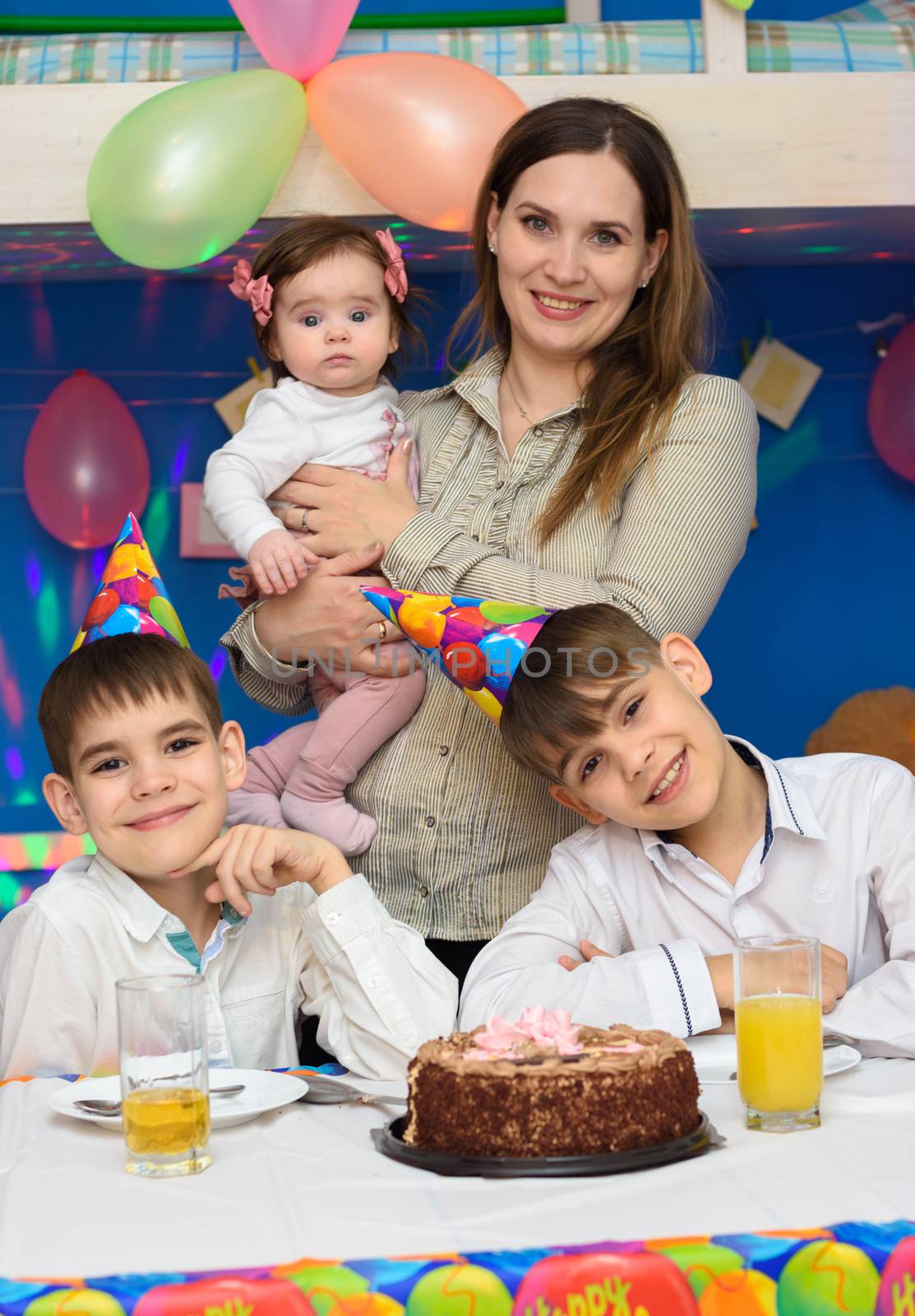 Portrait of mom and three children at a birthday celebration