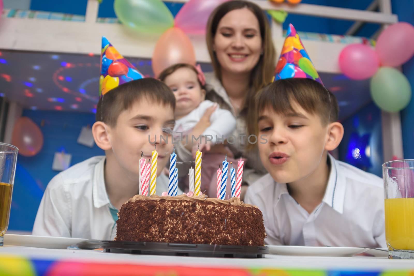 Children blew out candles on a holiday cake