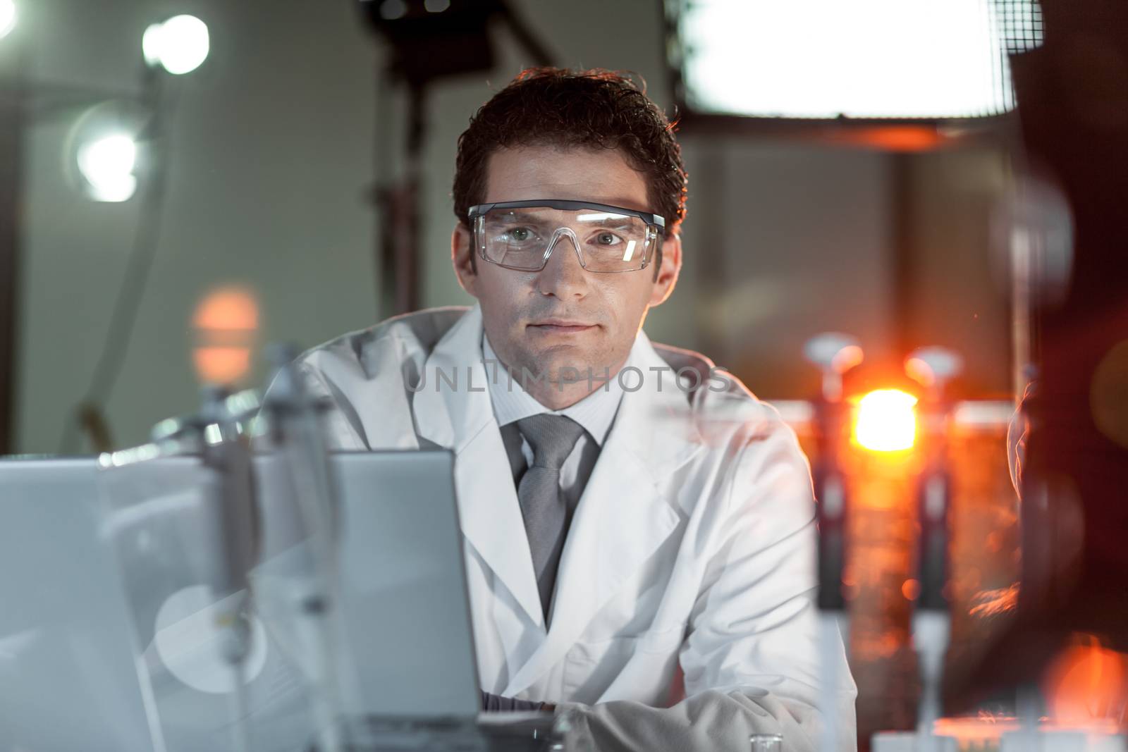 Portrait of a confident male engineer in his working environment. Science and technology concept.