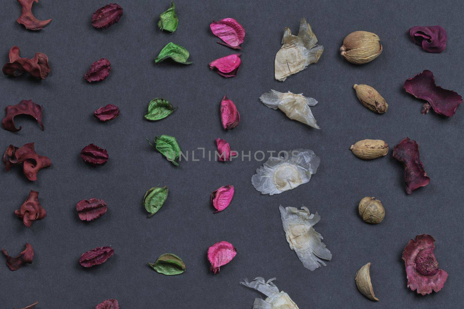 Potpourri on a black background. Flavored potpourri leaves. Dry potpourri leaves close-up. Geometric pattern