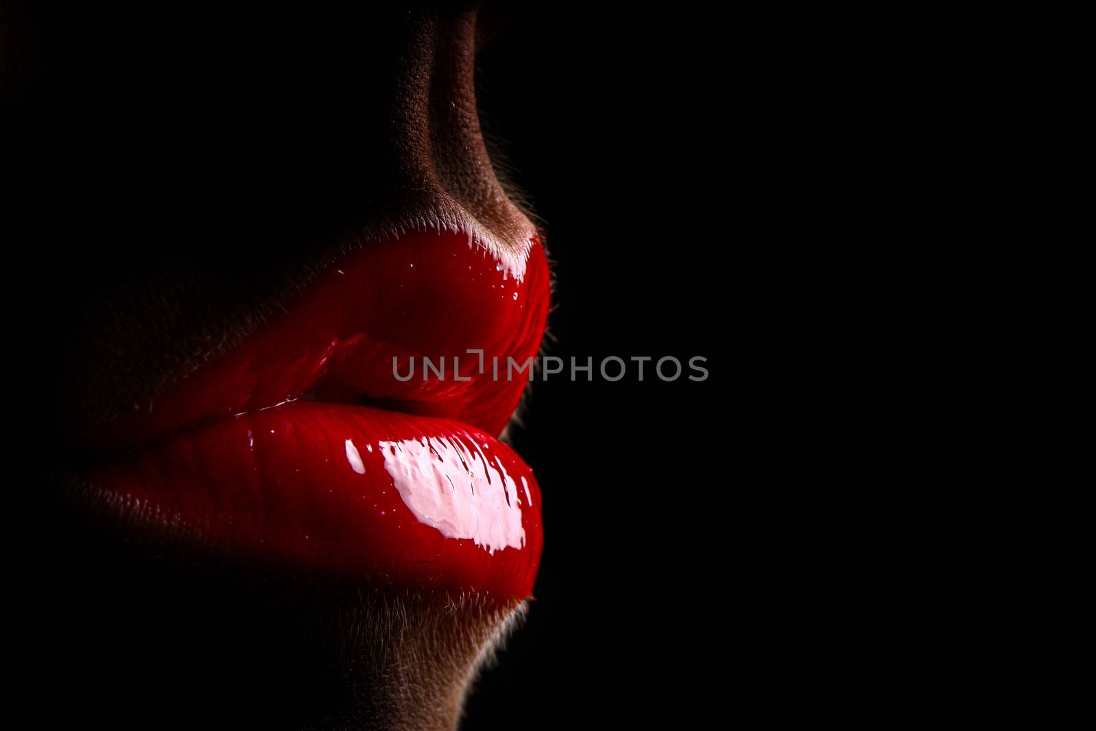 Full red lips an black background with copy space. Very high gloss
