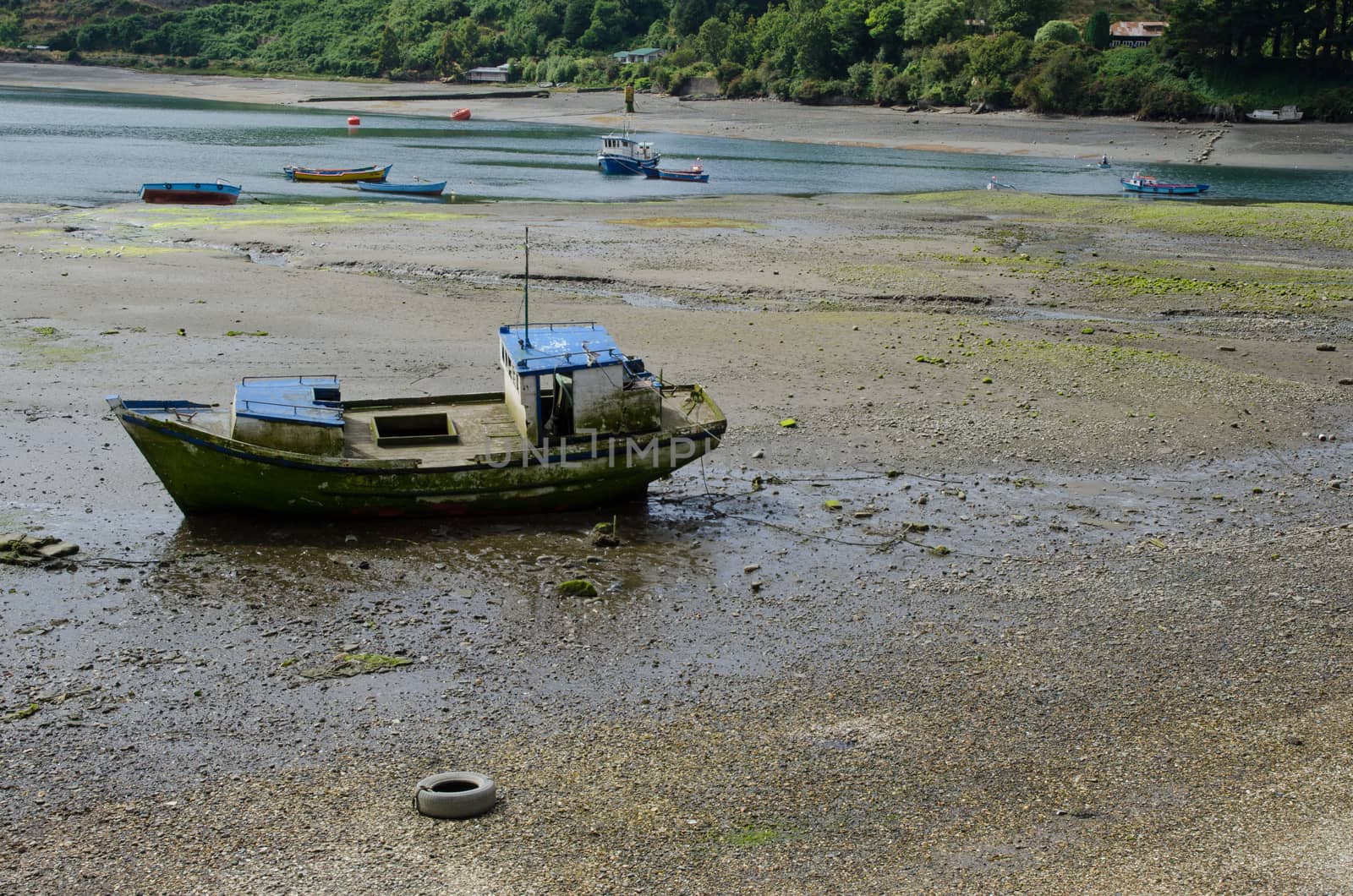 Fishing boat stranded in the coast. Angelmo. Puerto Montt. Los Lagos Region. Chile.