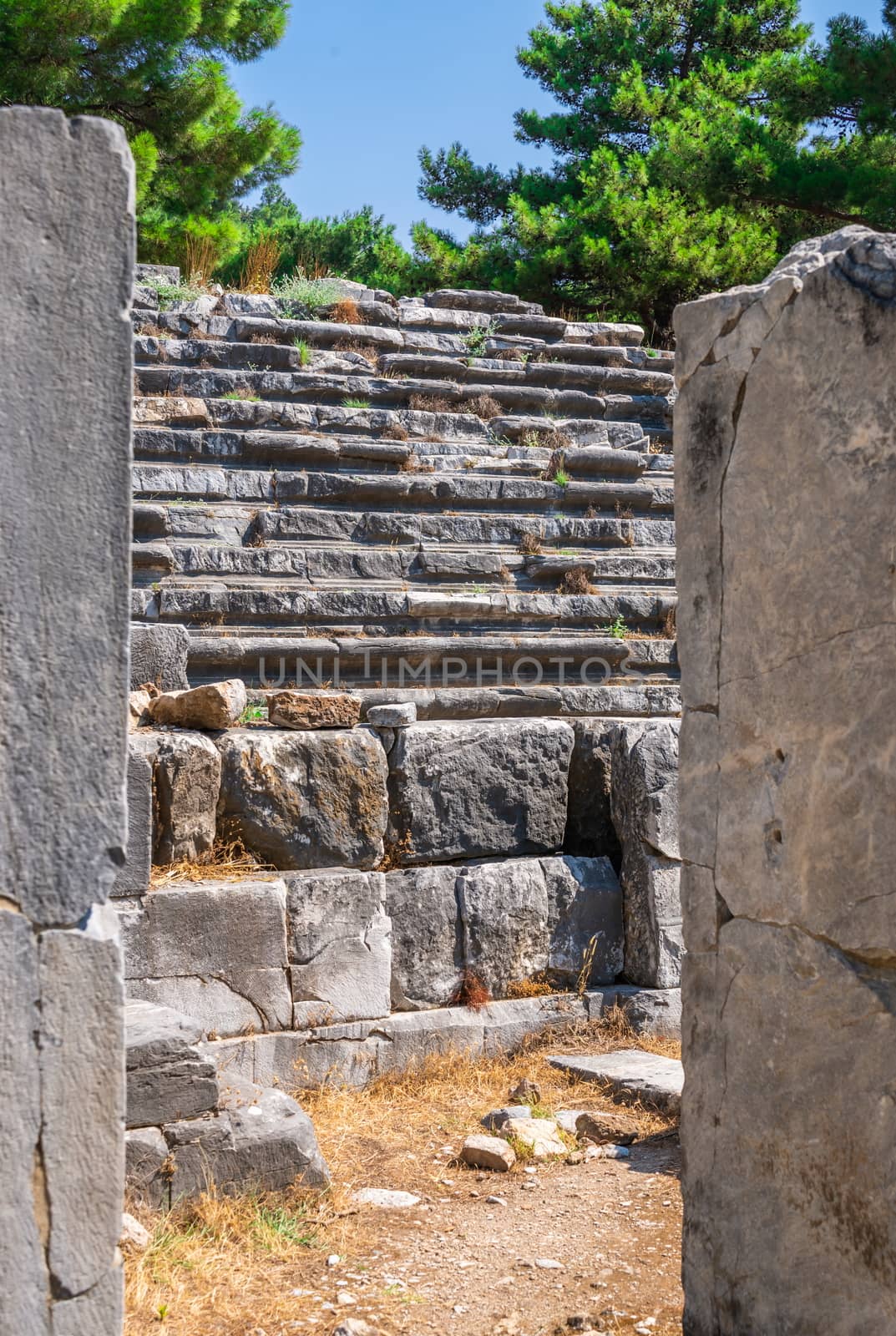 Ruins of the Ancient Theatre in the greek city of Priene in Turkey on a sunny summer day