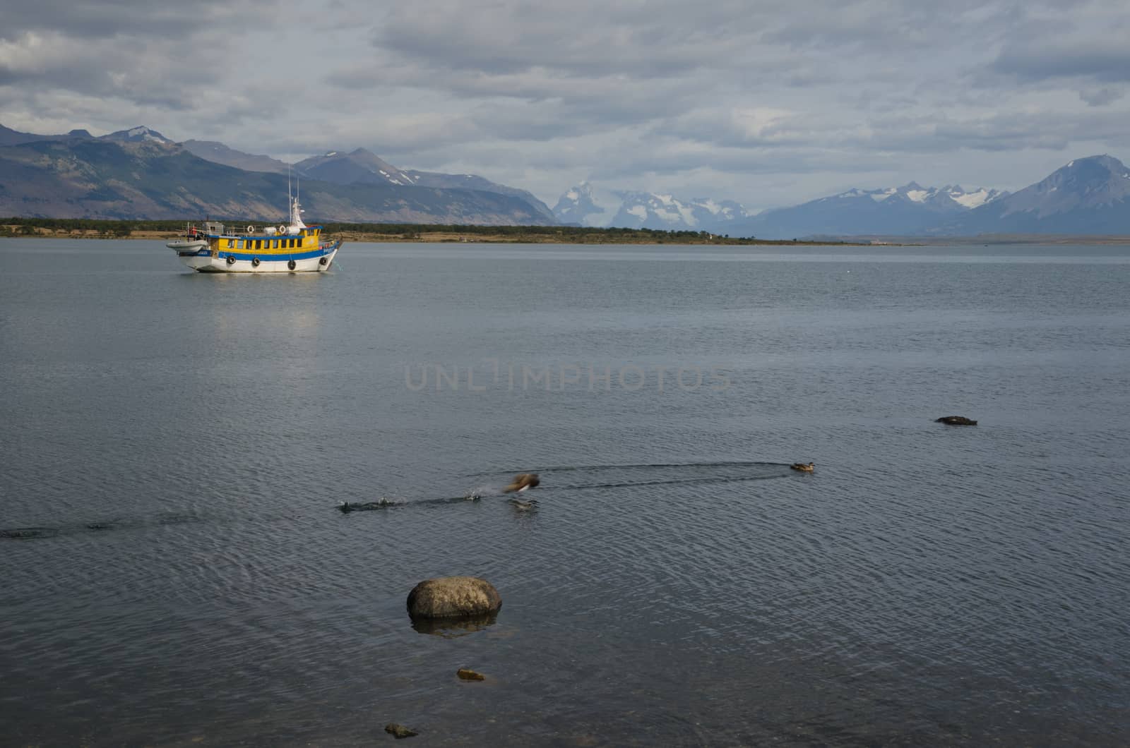 Tourist boat in the Ultima Esperanza Inlet and Sarmiento Mountain Range. by VictorSuarez