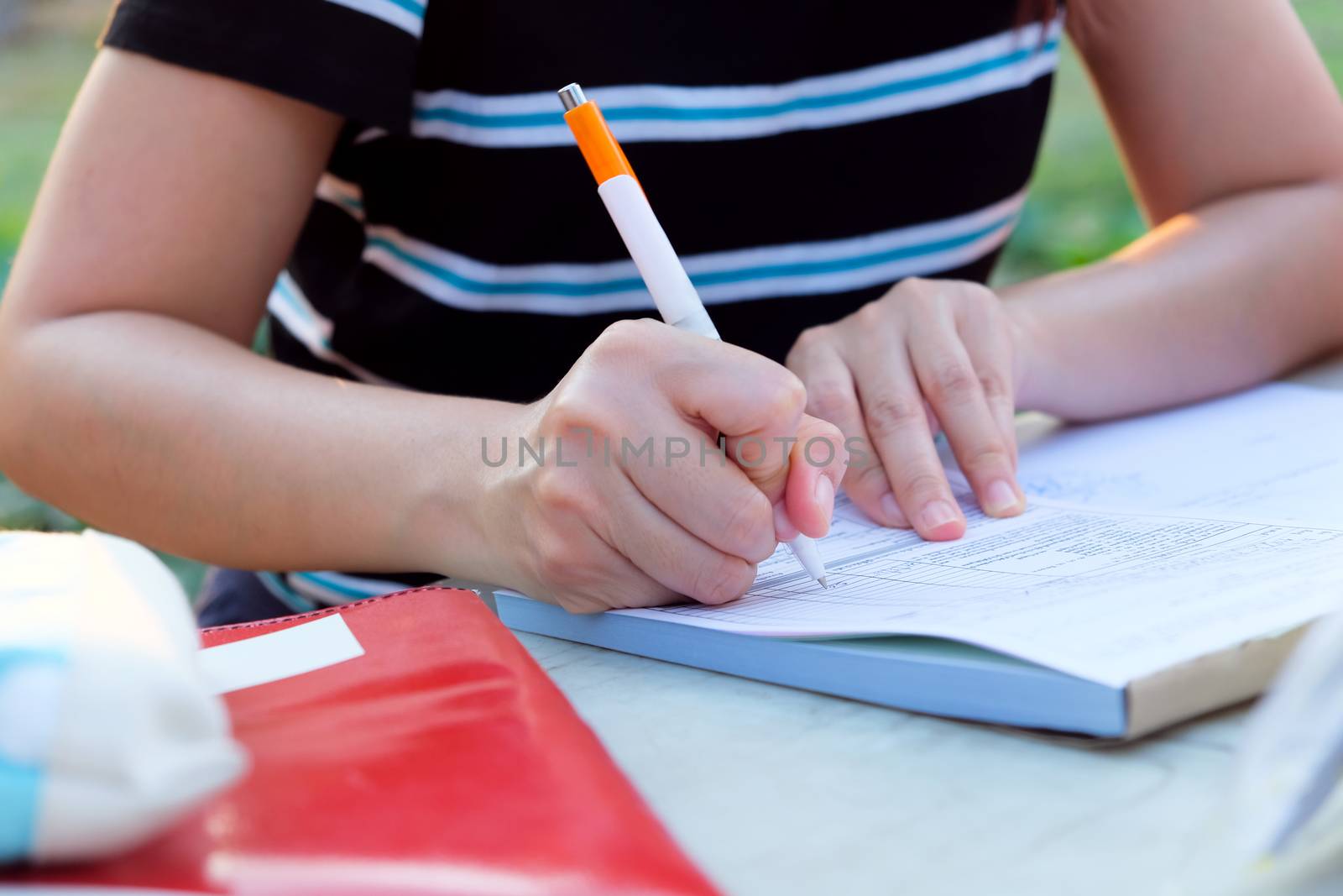 Close up female hands of accountant with calculator and pen. business accounting background.