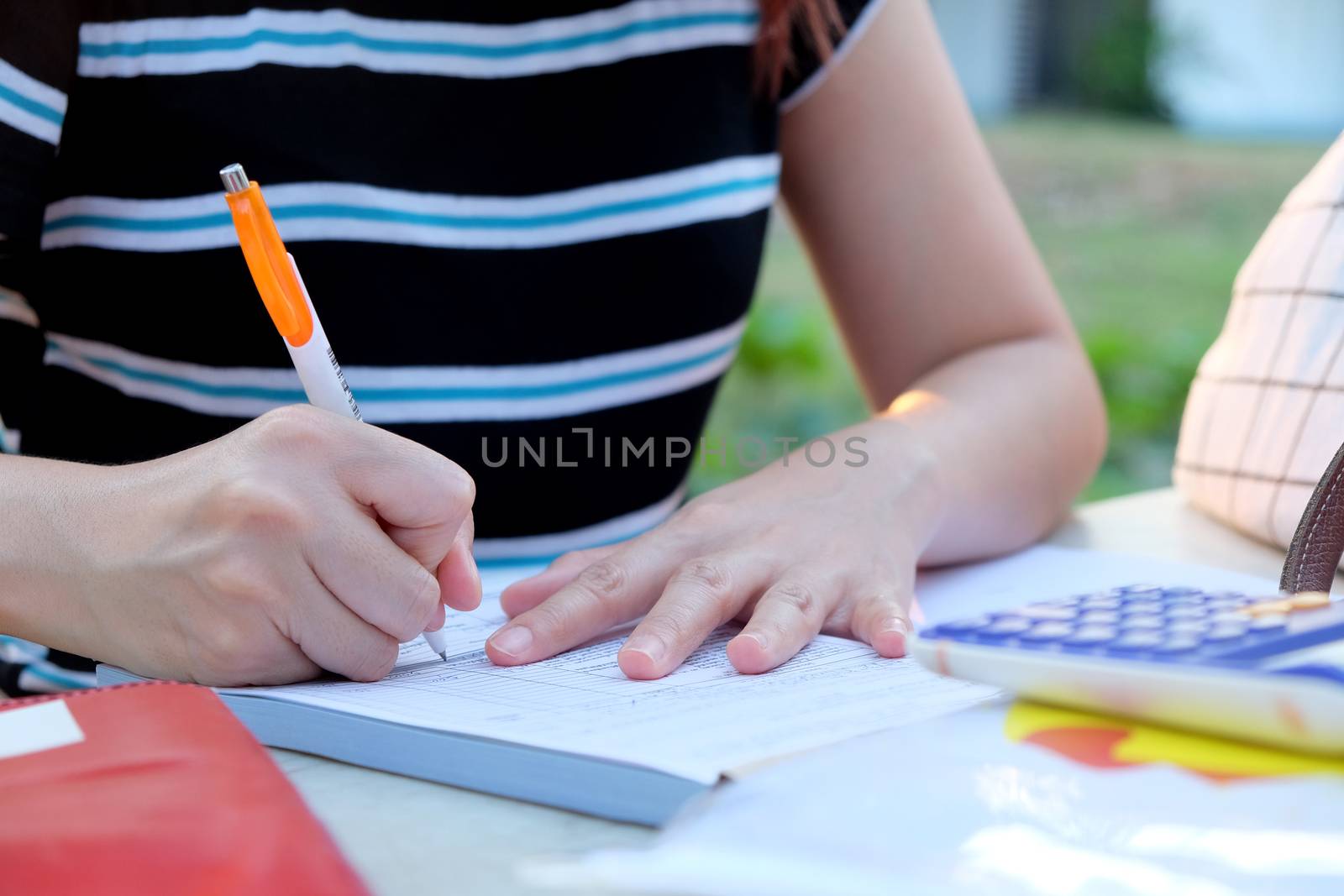 Close up female hands of accountant with calculator and pen. business accounting background.