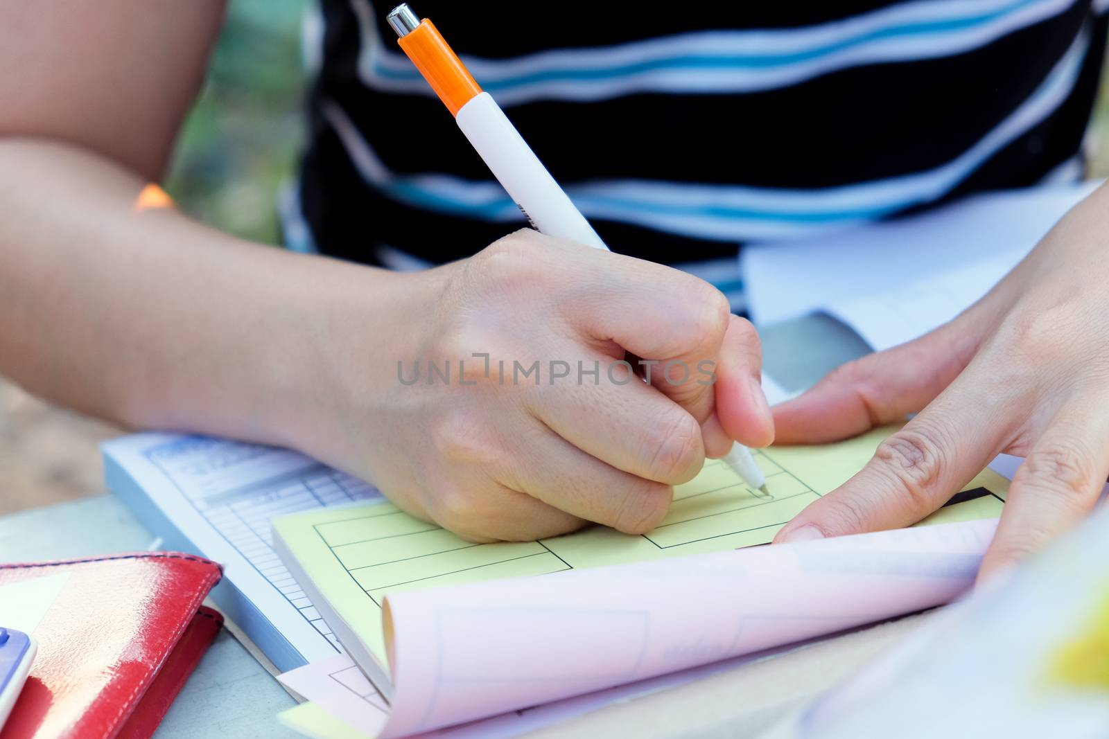 Close up female hands of accountant with calculator and pen. business accounting background.