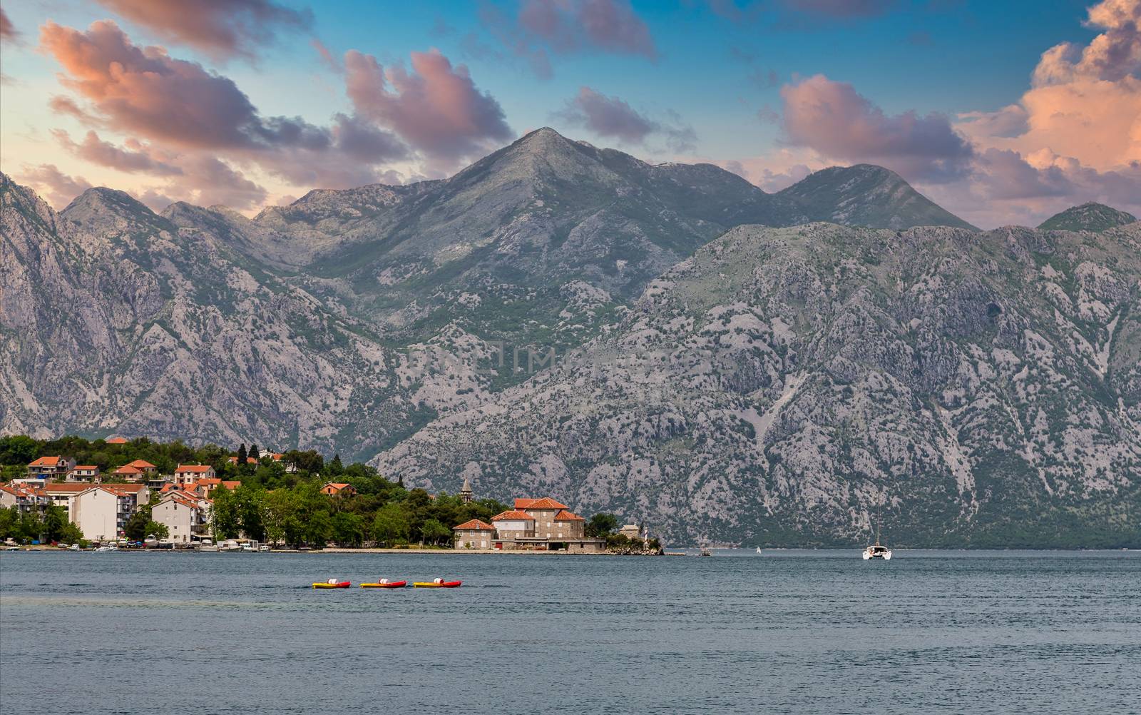 Old, red tile roofed buildings on the coast of Montenegro near Kotor