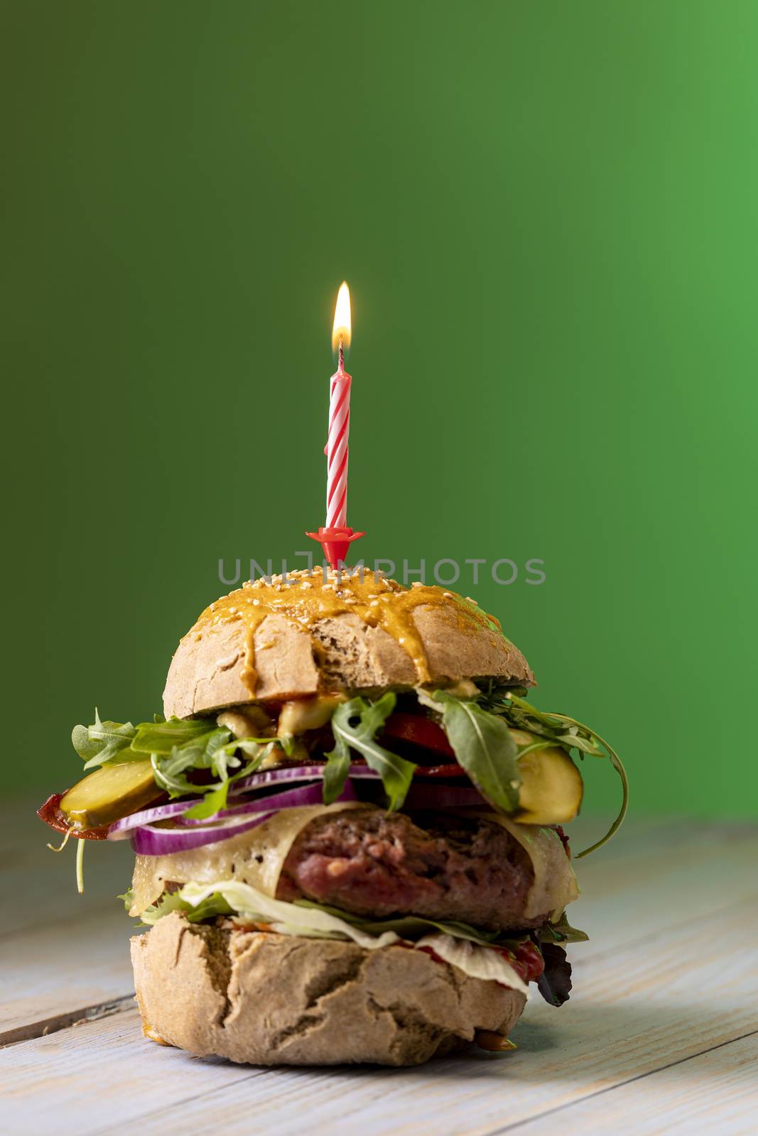 home made cheeseburger on dark wood by bernjuer