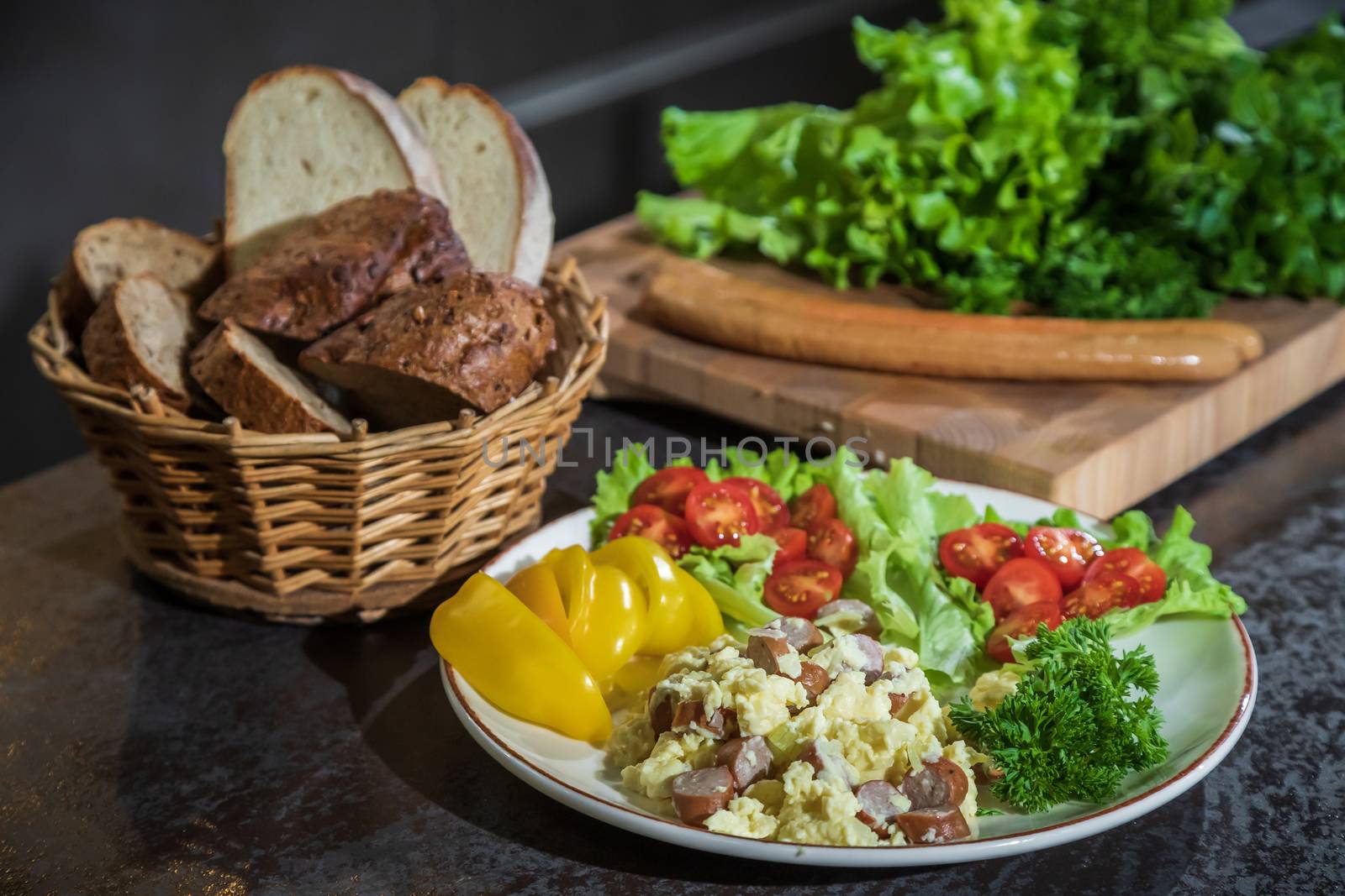 Omelet with herbs and vegetables on a gray table in the kitchen