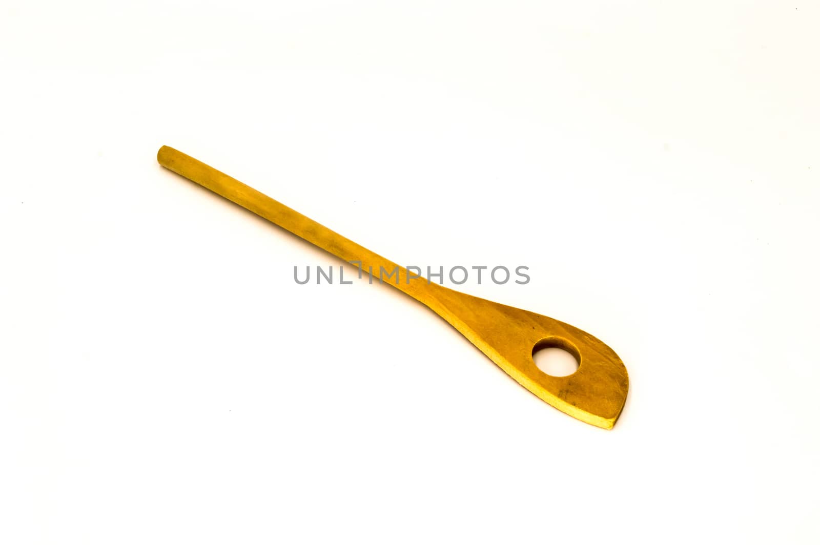 Wooden spoon with a hole on a white background