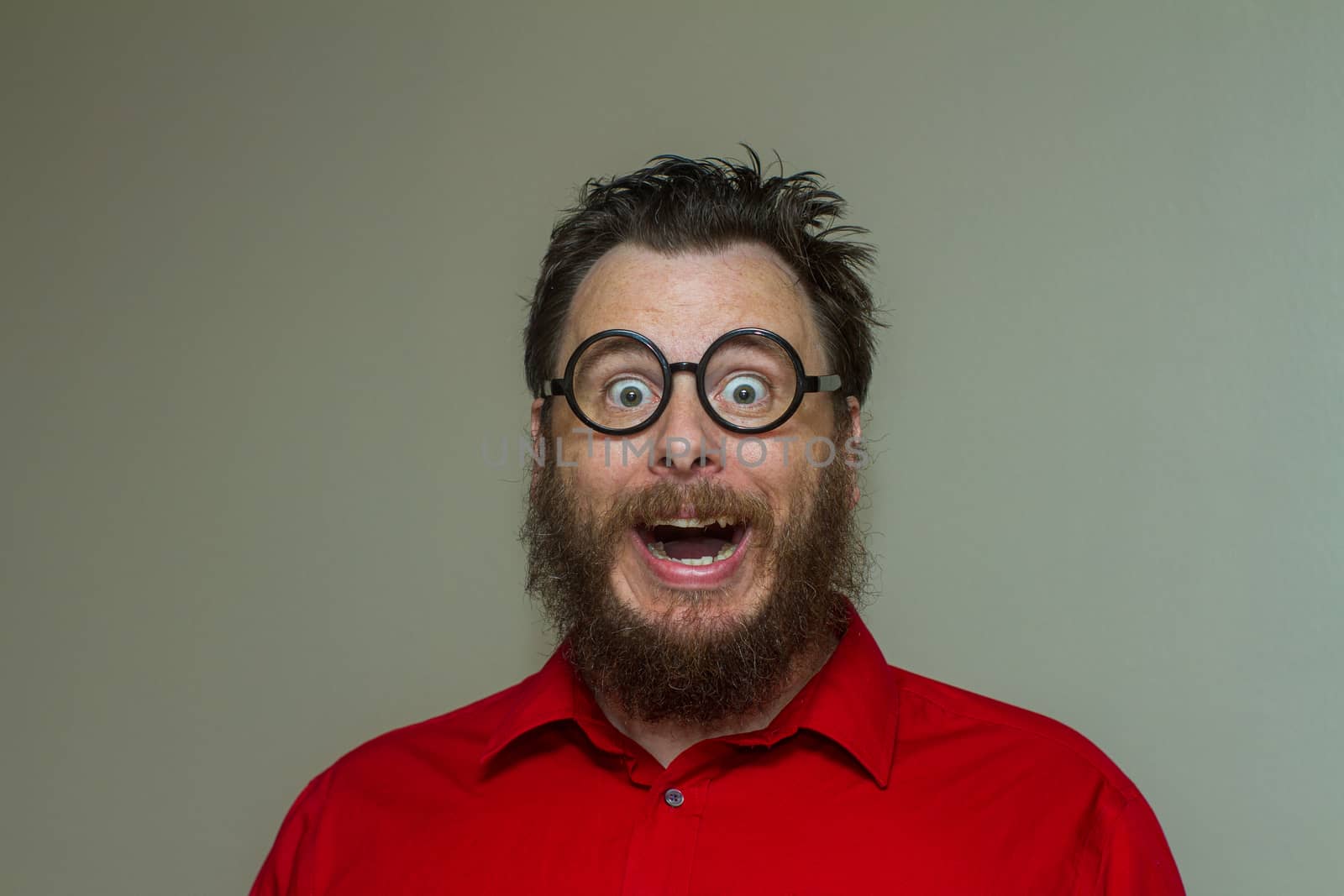 Man wearing a dress shirt with messy hair making a huge smile face