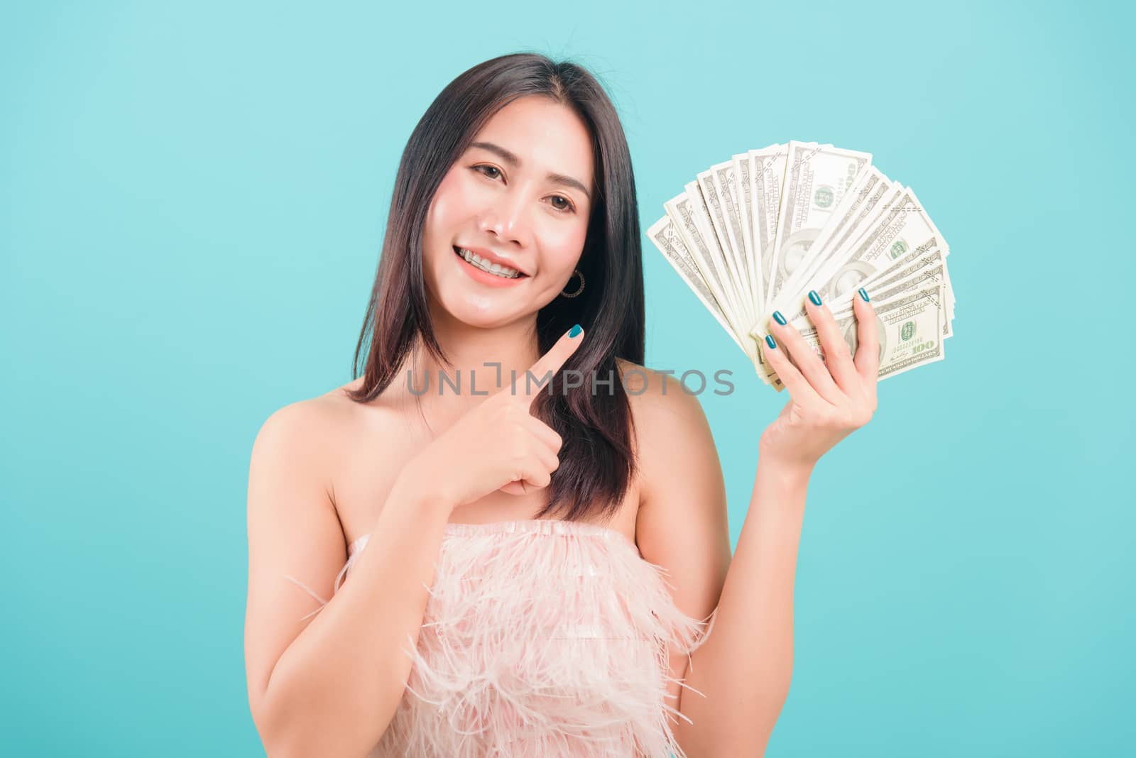 woman standing smile her celebrating holding dollar money fan ba by Sorapop