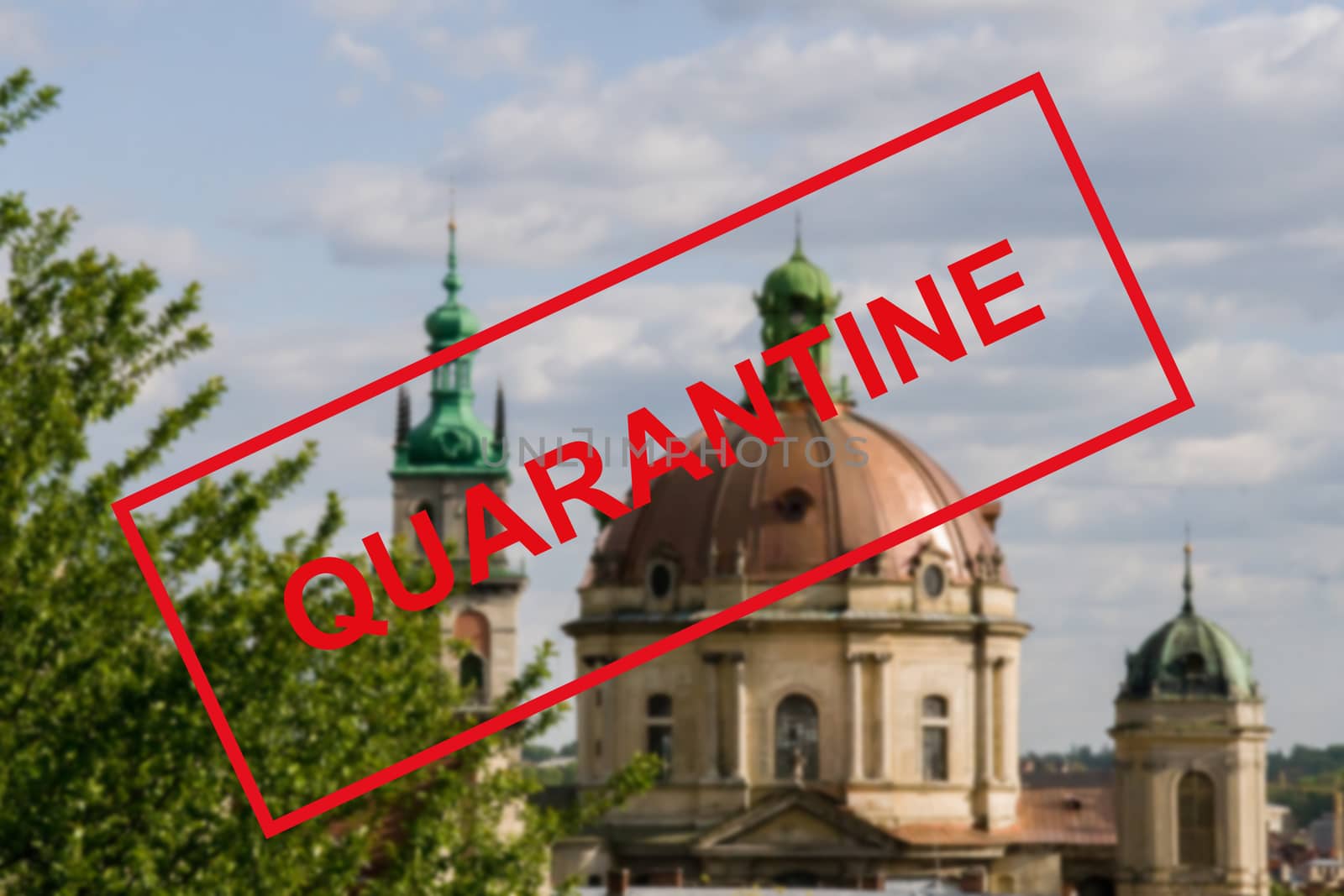 Warning text about a coronavirus outbreak in Ukraine against a blurred background of the ancient architecture of the Ukrainian city of Lviv. Coronavirus and quarantine for travel and tourism, pandemic covid-2019