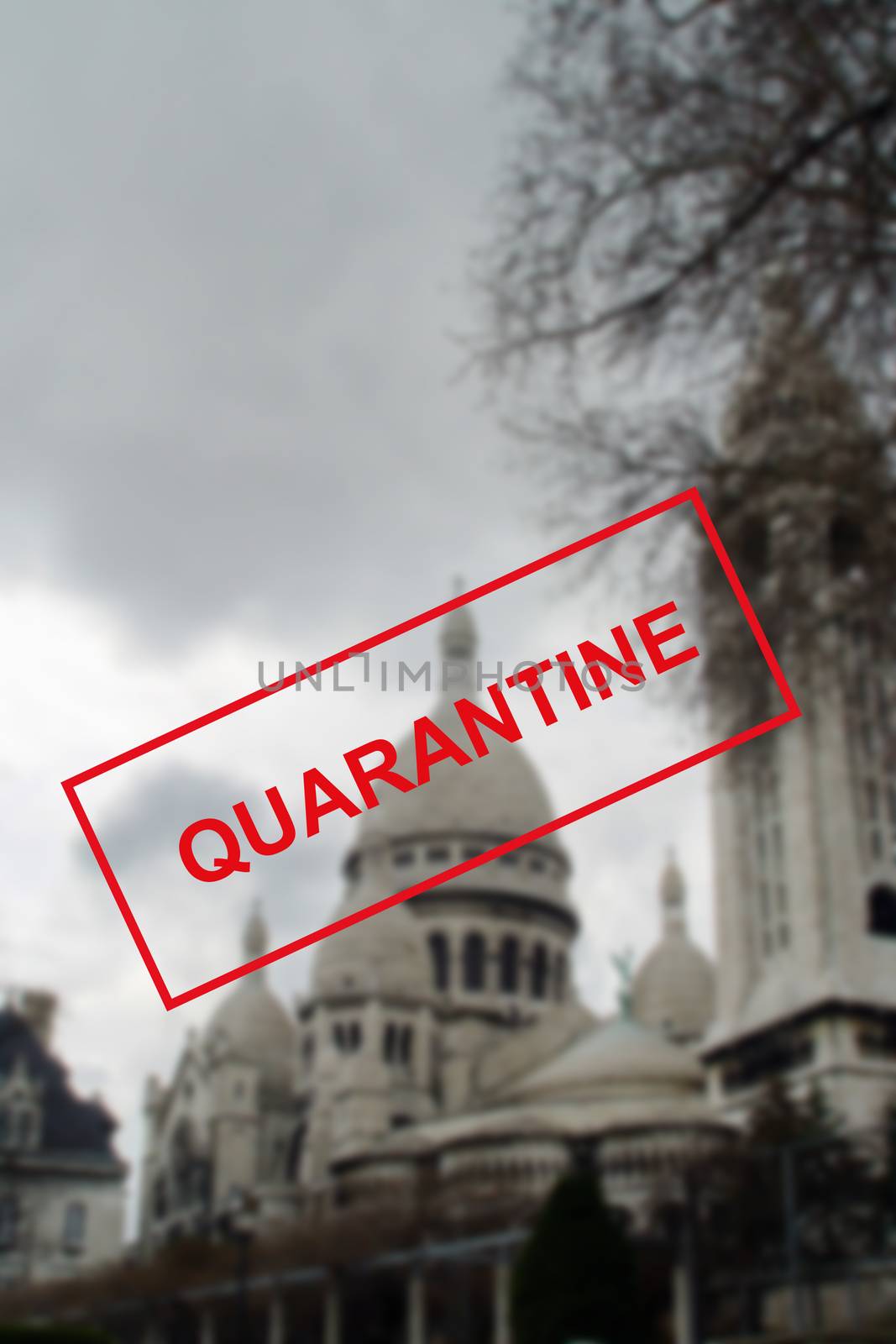 COVID-19 coronavirus in France, text Quarantine in photo of The Basilica of the Sacre Coeur, or Basilica of the sacred Heart, is an extraordinarily beautiful Catholic Cathedral on the hill of Montmartre in Paris. Concept of COVID pandemic and travel in Europe.