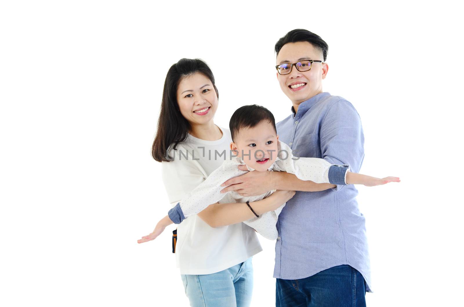 Happy family carry their son and having fun