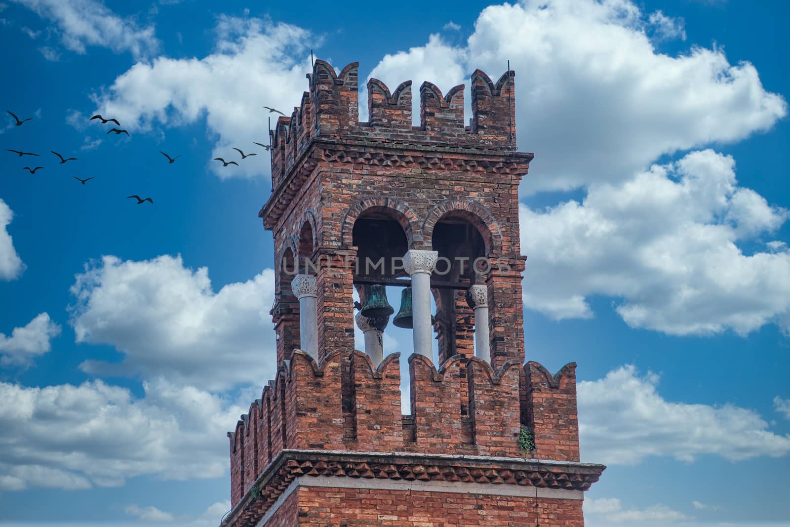 A brick bell tower against the sky in Venice