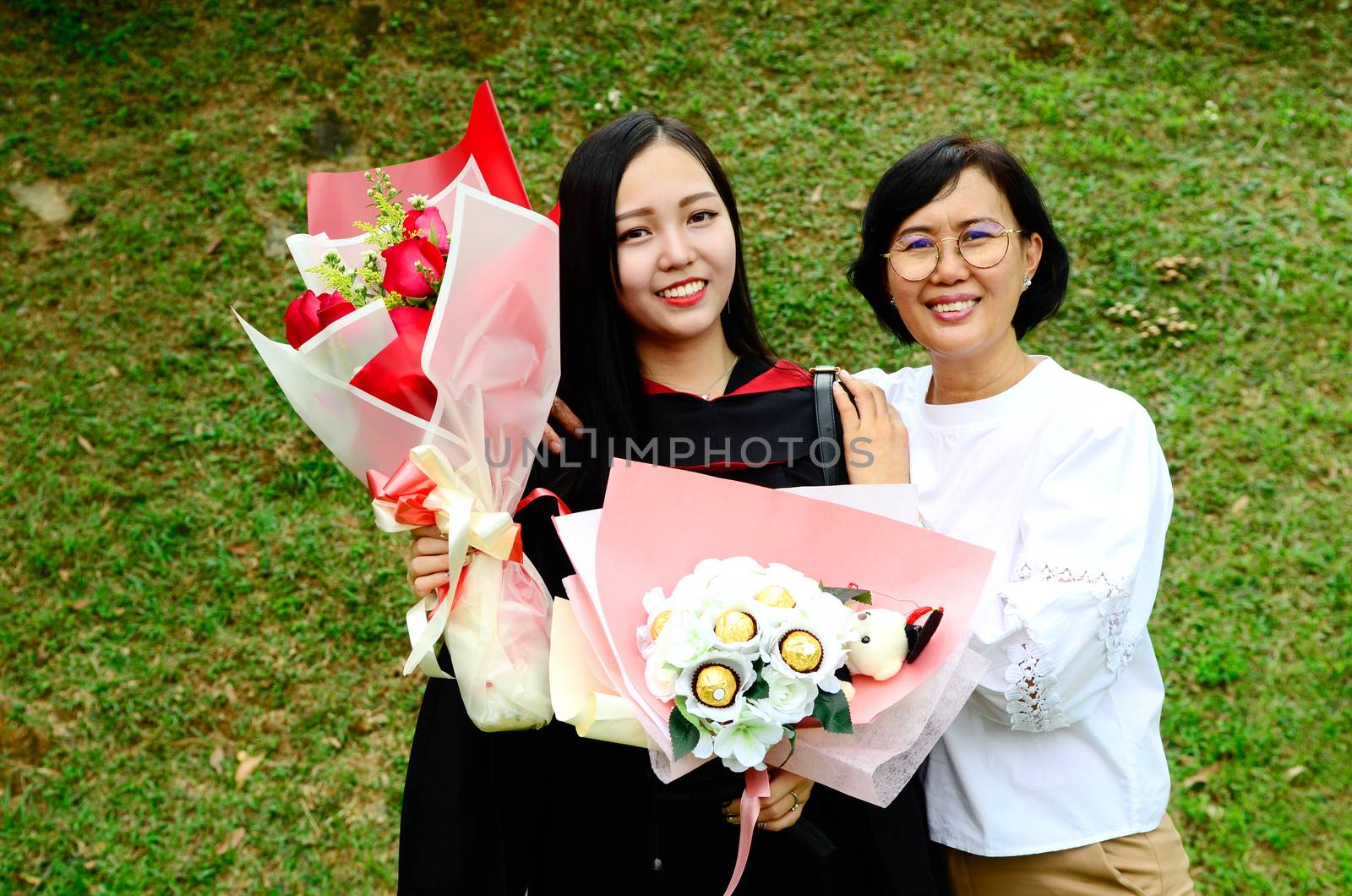 Asian university student and mother celebrating graduation