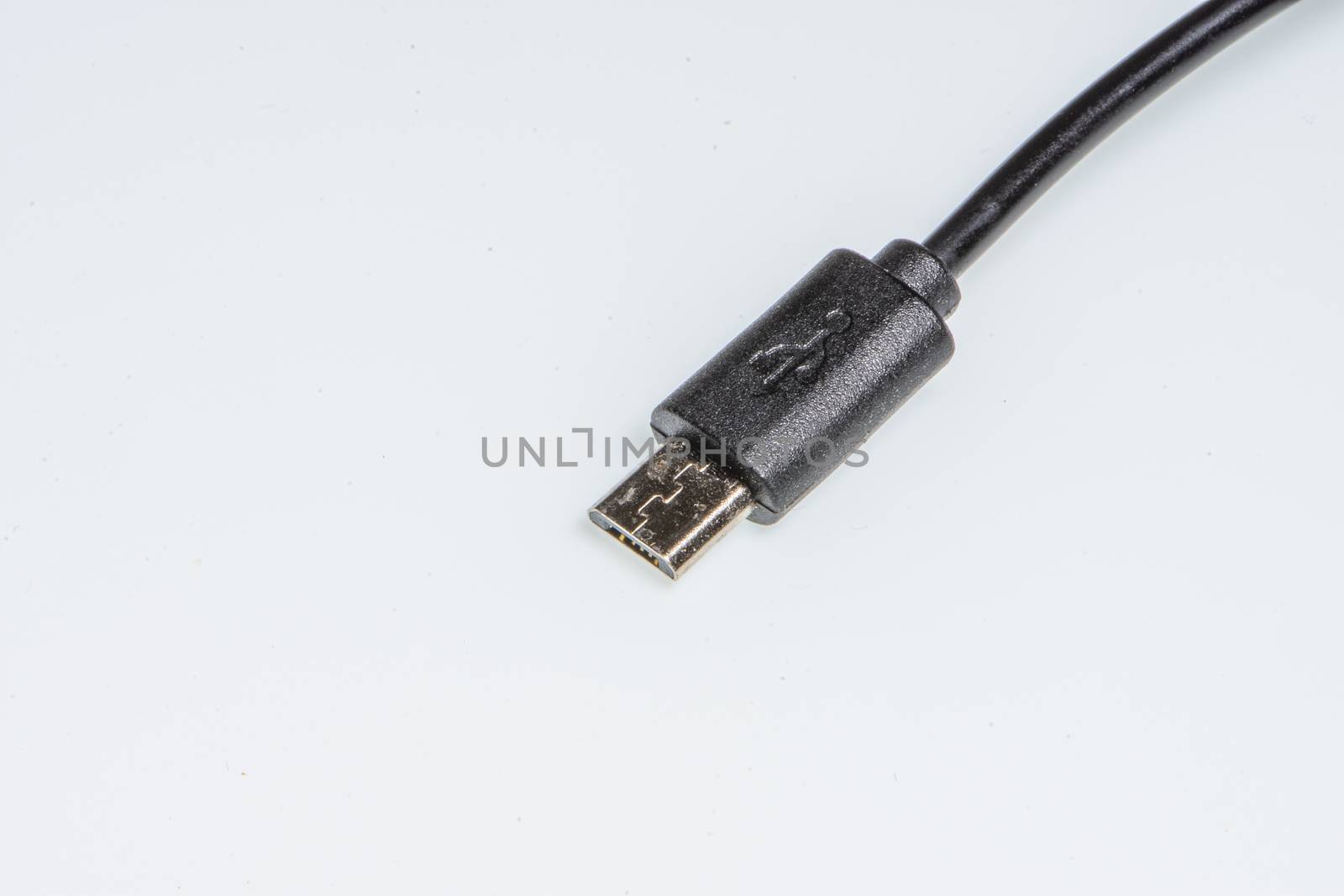 detail of a black micro usb connector on a white background