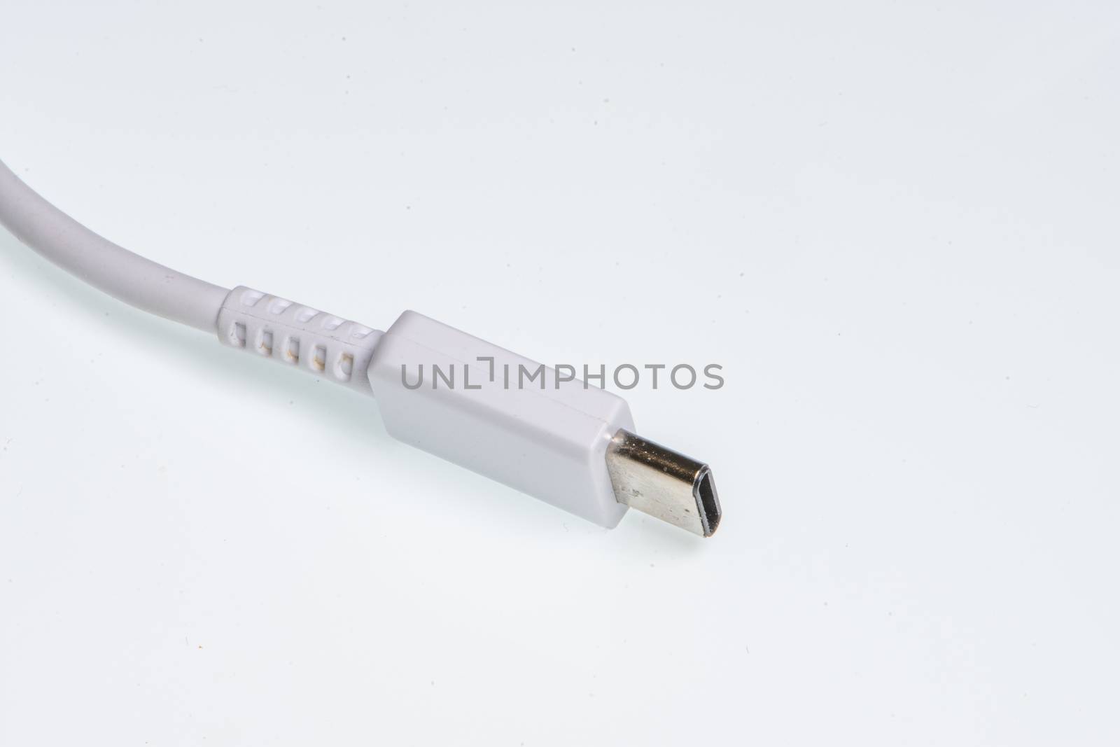 detail of a white usb-c connector on a white background