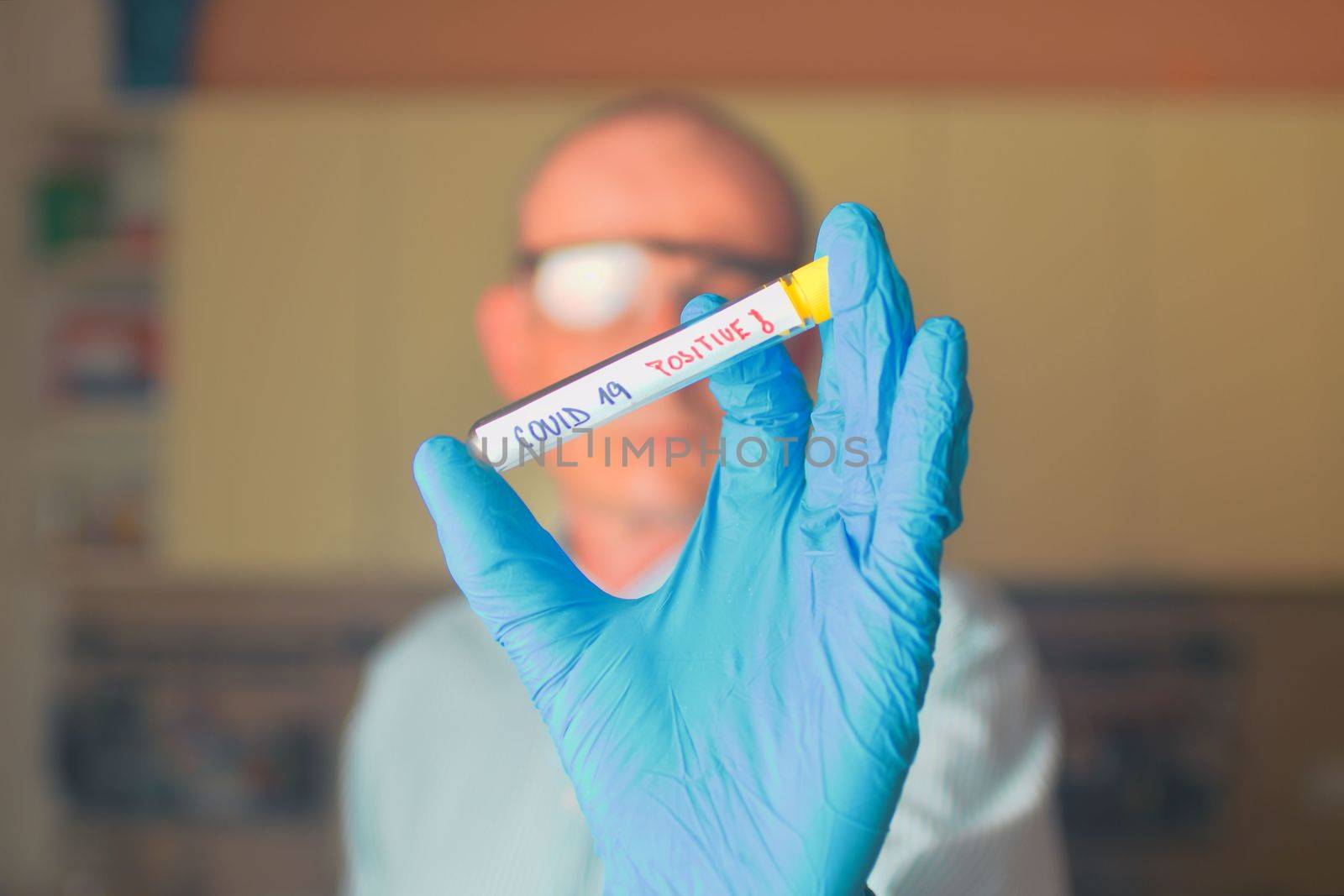 The sample of Covid 19 in the test tube. Doctor - epidemiologist holding thesample tube with sample of coronavirus. by roman_nerud