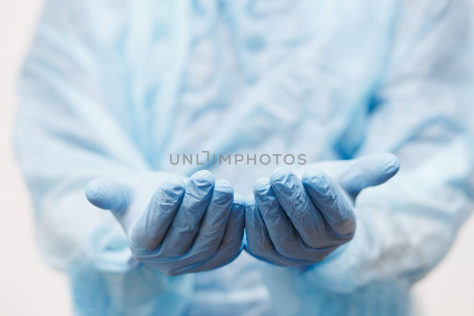 Close up of doctor hand holding. Mock up. Medical equipment. A doctor wearing personal protective equipment to protect COVID 19 coronavirus infection. by Denys_N