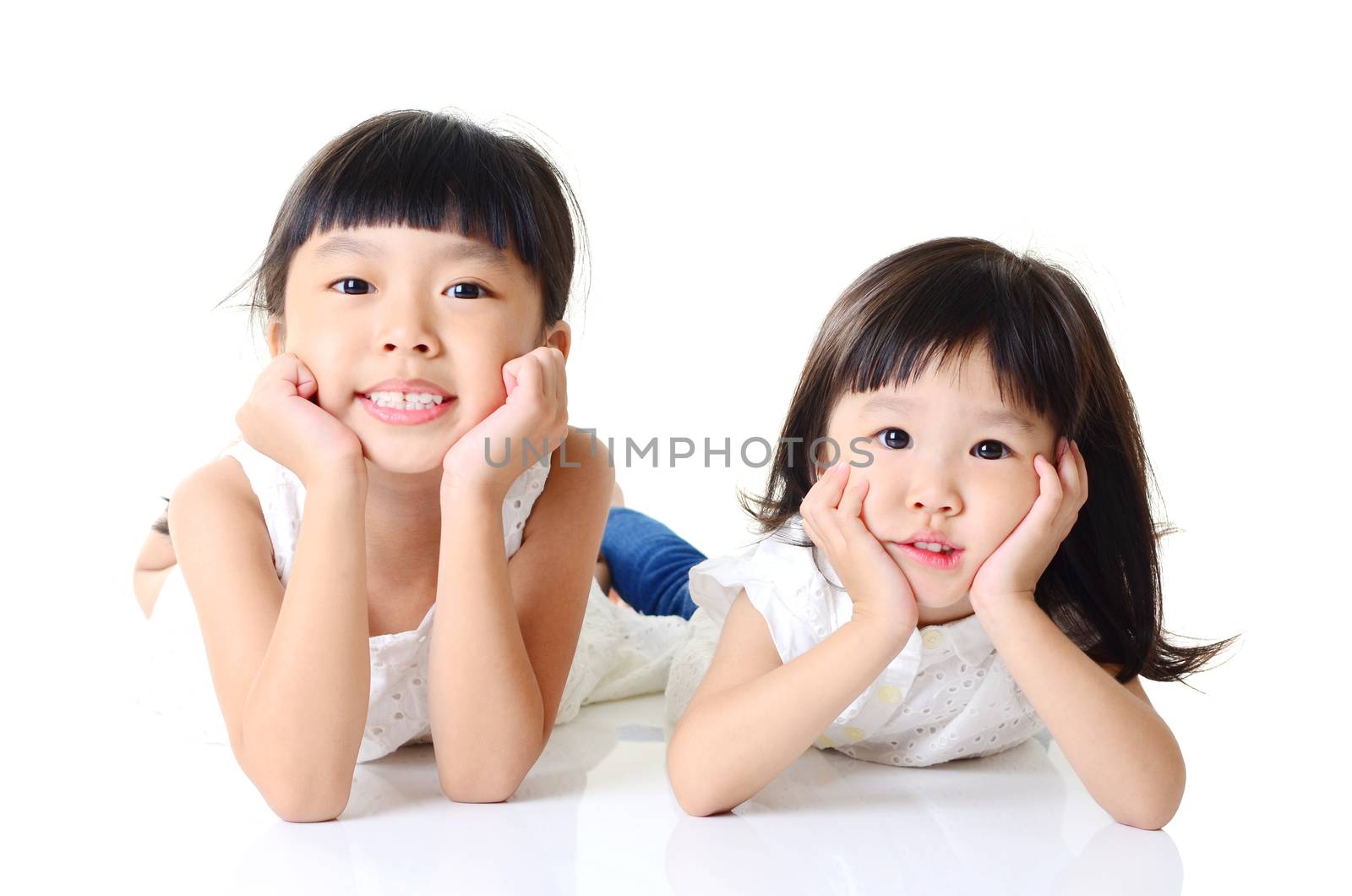 Asian kids lying on the floor on white background