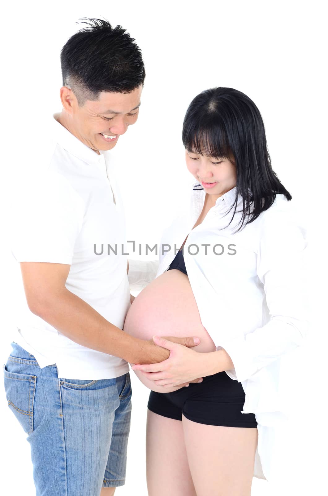 Beautiful young Asian couple expecting baby