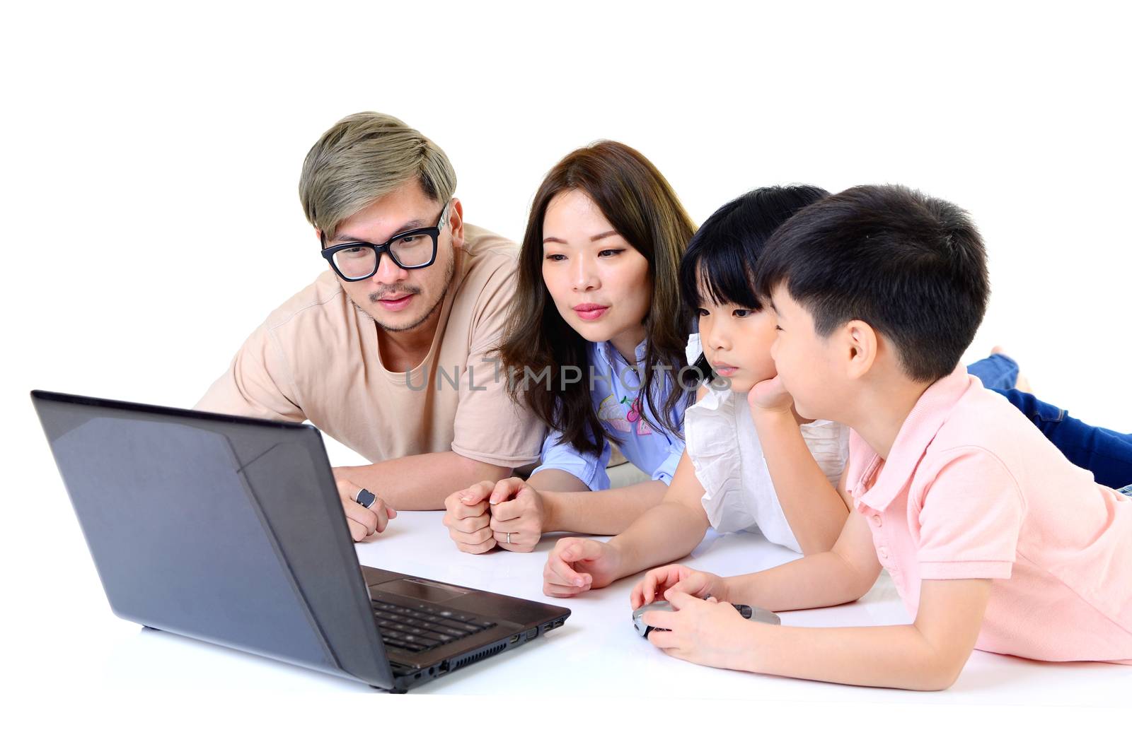 happy asian family with children looking at laptop