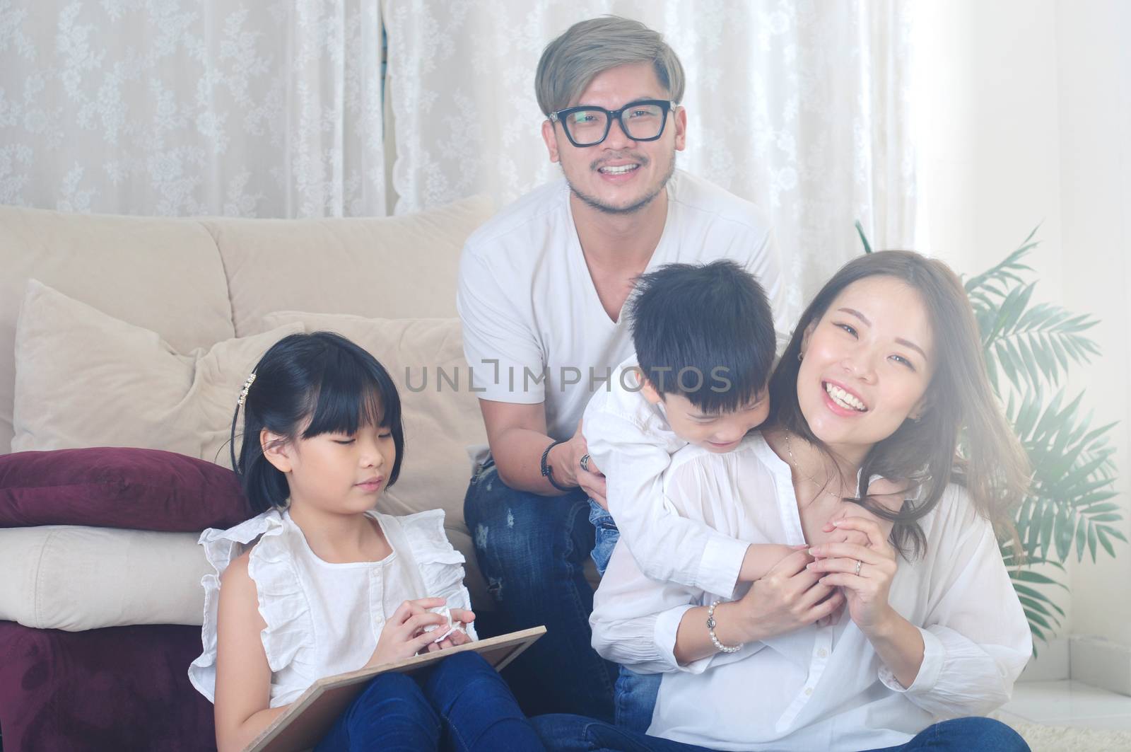 Asian family enjoying family life at living room