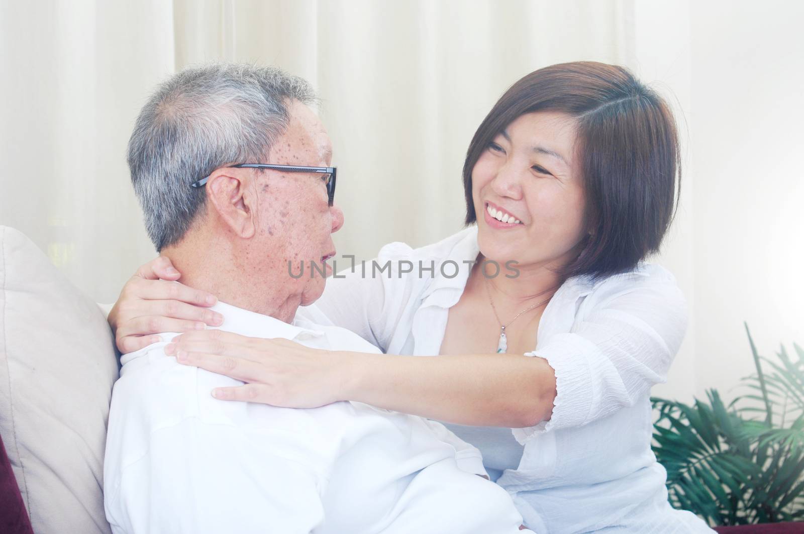 Senior man and daughter. Happy Asian family senior father and adult offspring having fun time at indoor studio.