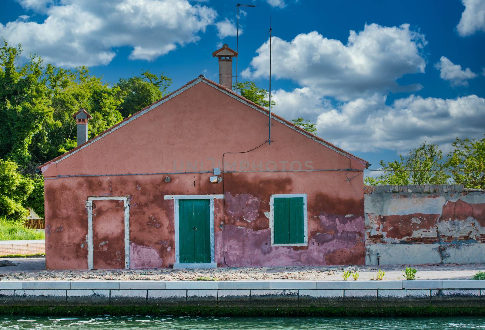 Old Red Plaster Building with Green Door by dbvirago