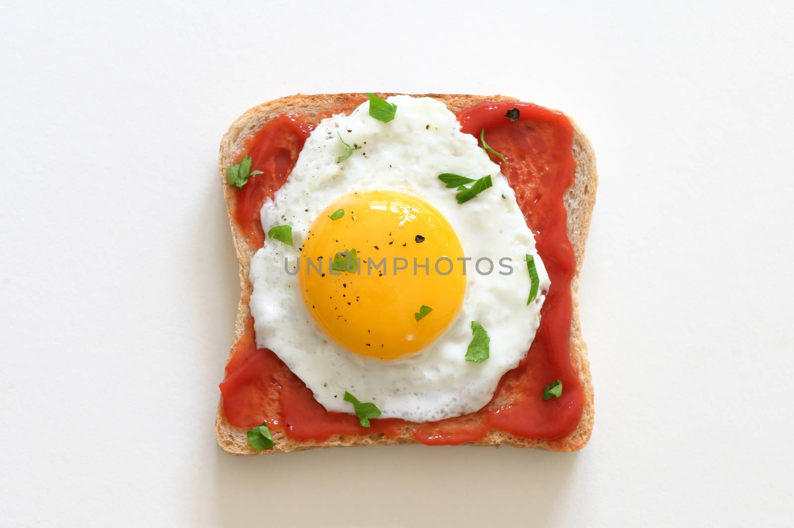 Fried Egg On Slice Of Toast Isolated on White Table