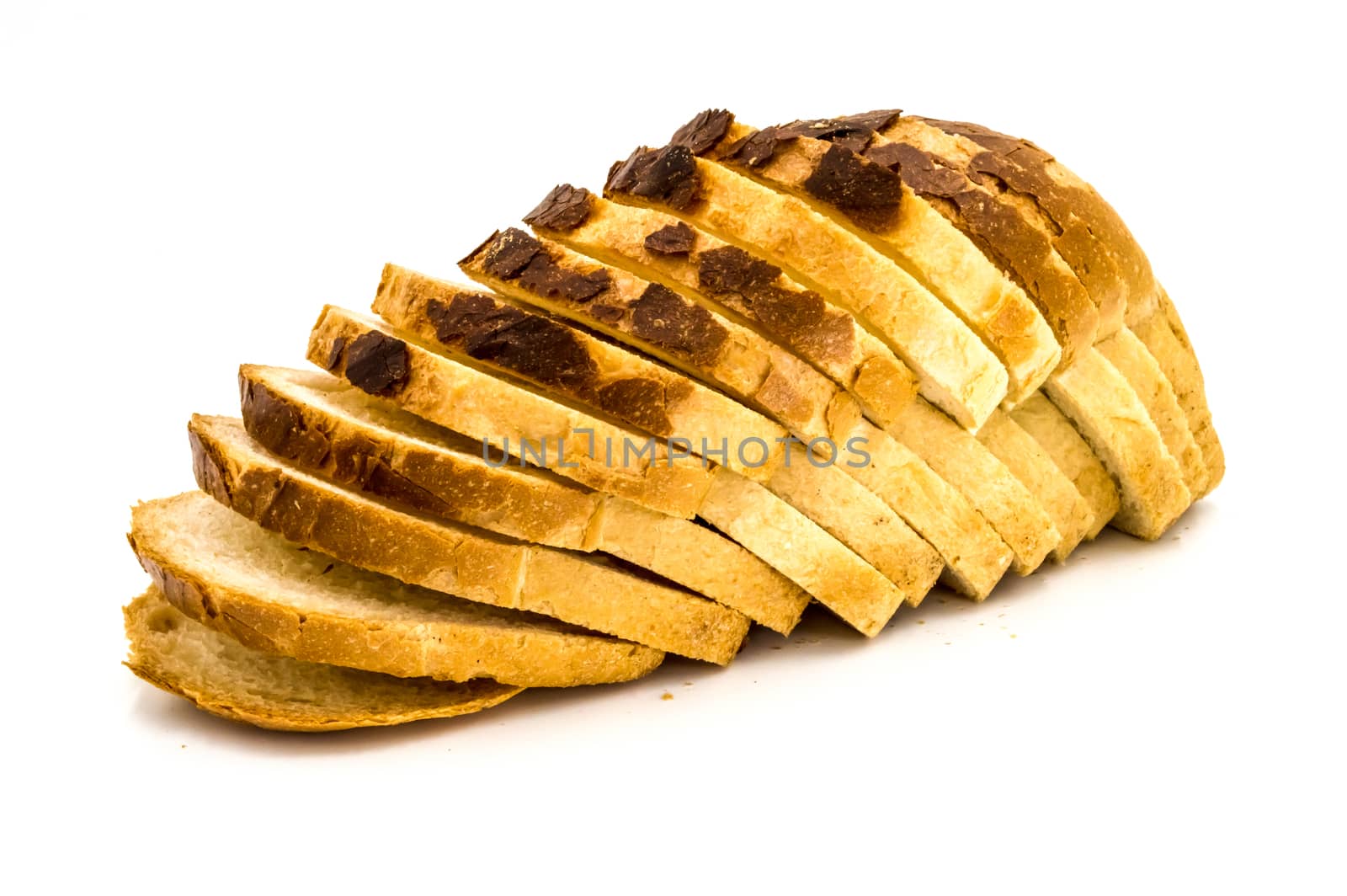 Homemade bread cut into slices on a white background
