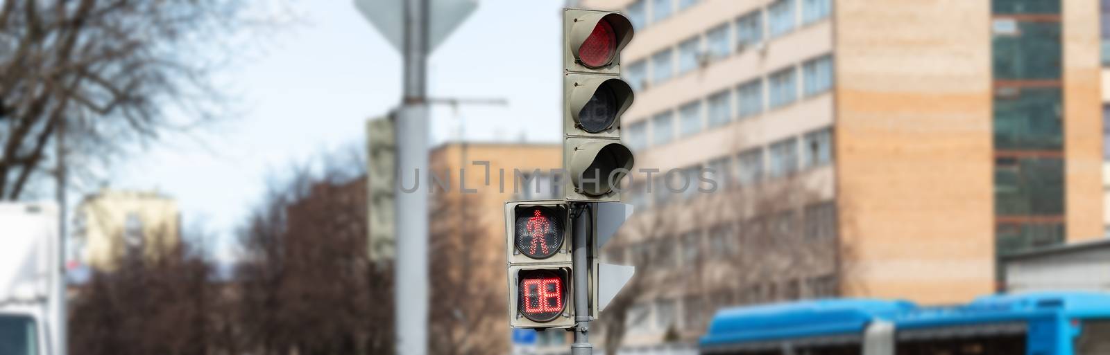 The traffic light shows red, which prohibits traffic for people. by bonilook