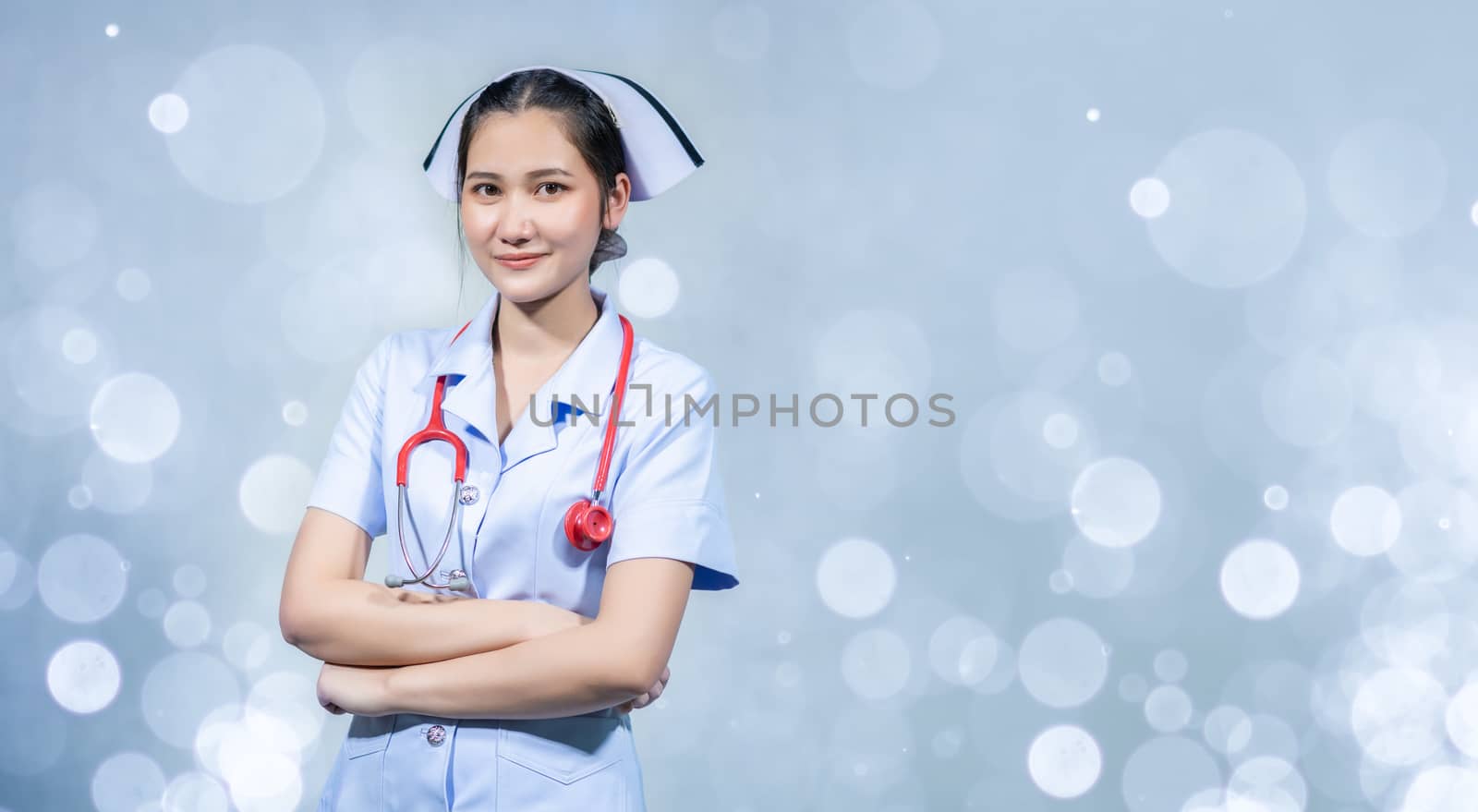 The nurse stood with his arms crossed on a white ground.