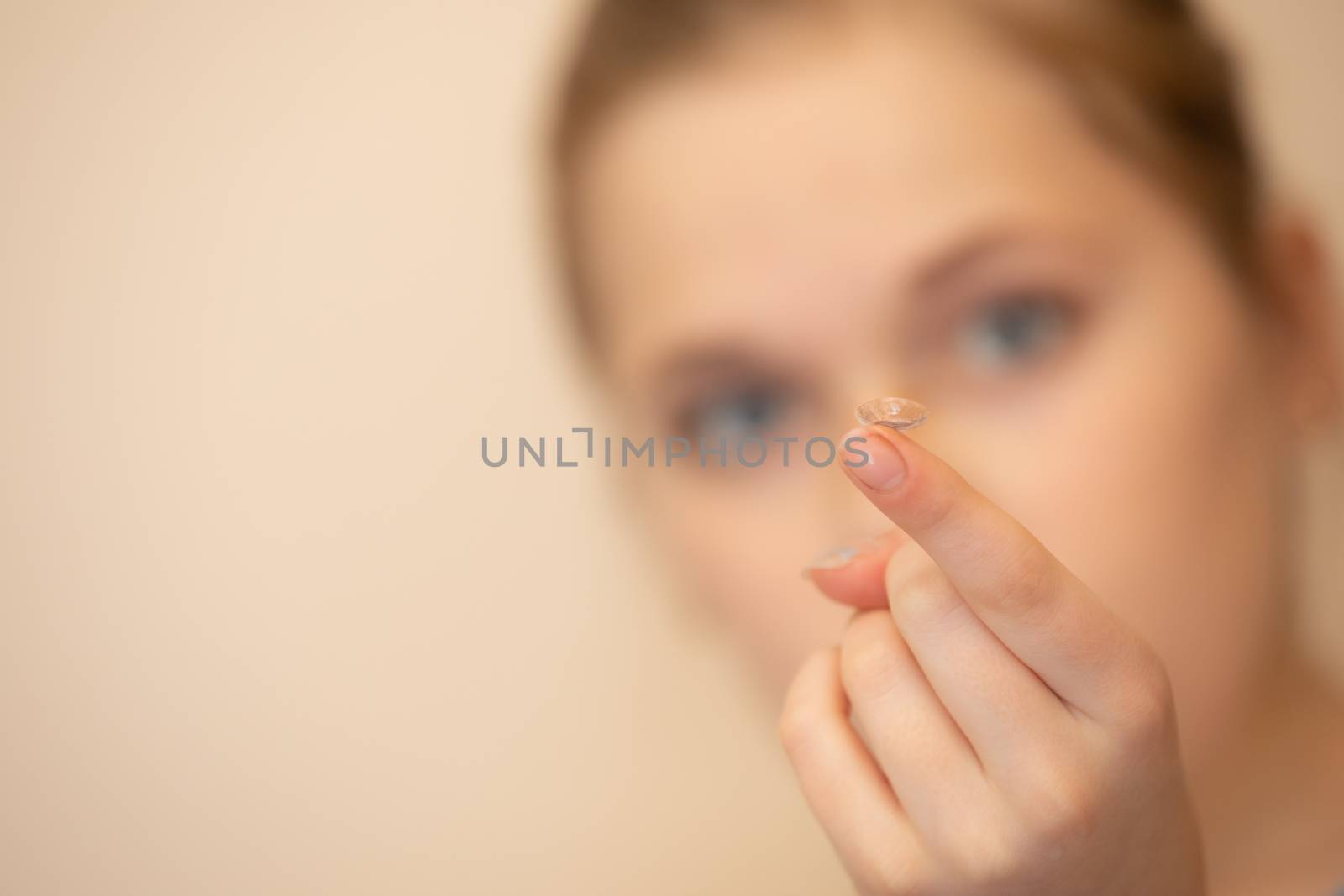 Contact being held out for use on a girls finger