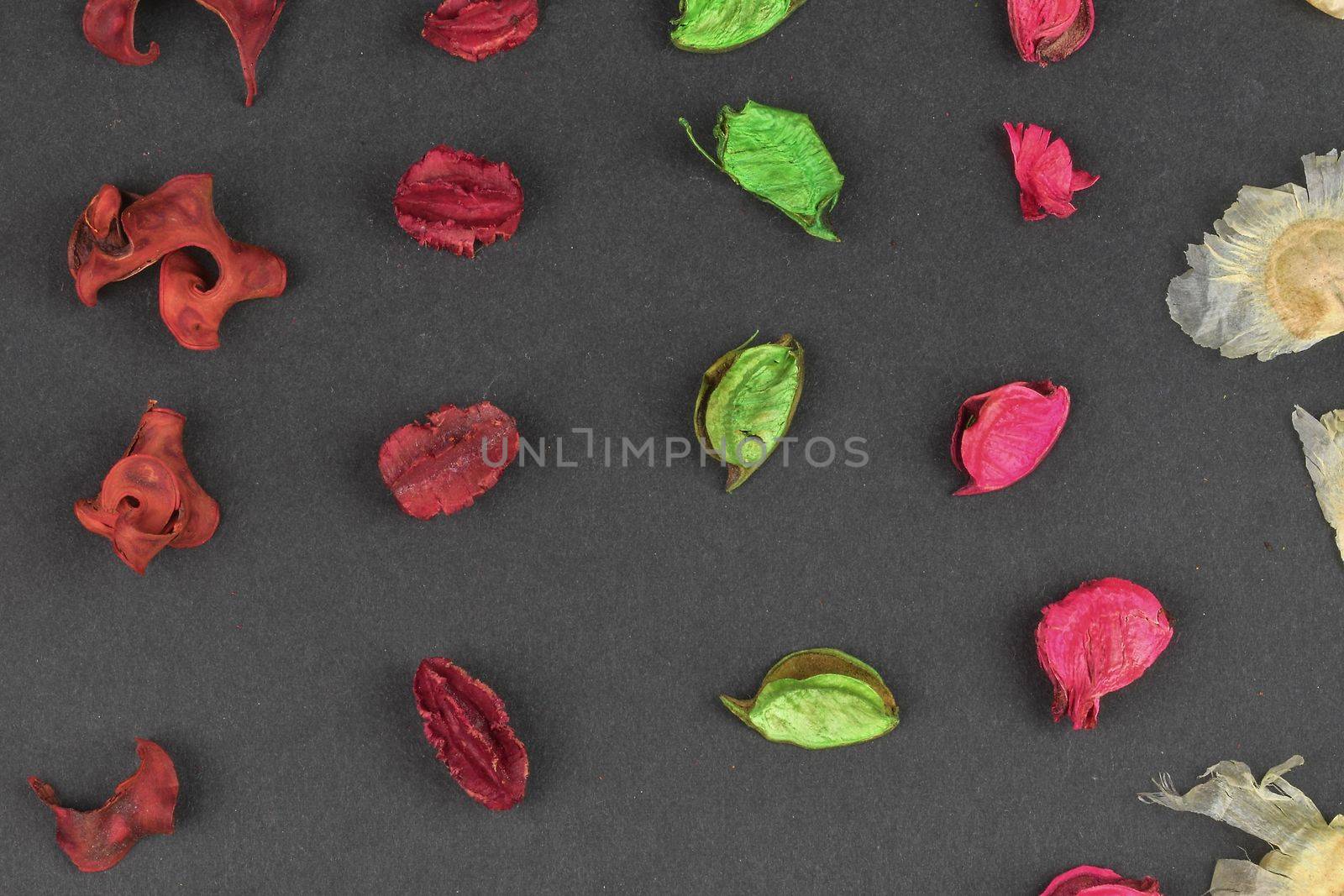 Potpourri on a black background. Flavored potpourri leaves. Dry potpourri leaves close-up. Geometric pattern. Closeup