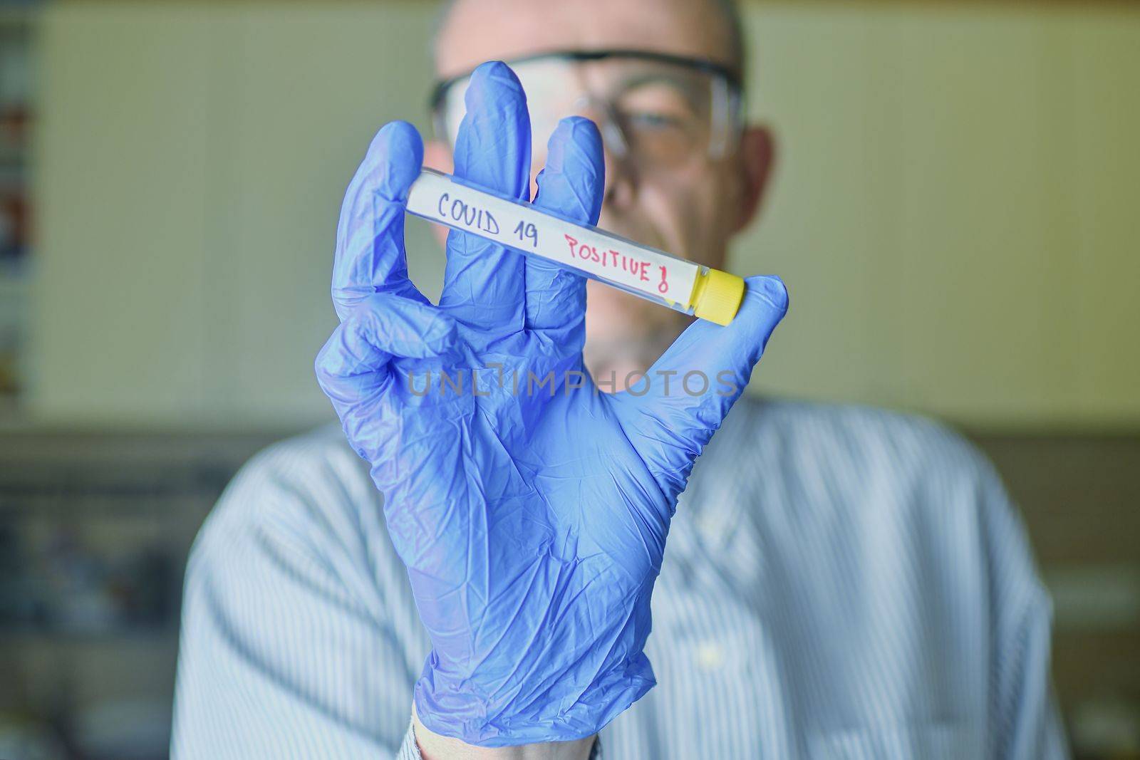 The sample of Covid 19 in the test tube. Doctor - epidemiologist holding thesample tube with sample of coronavirus