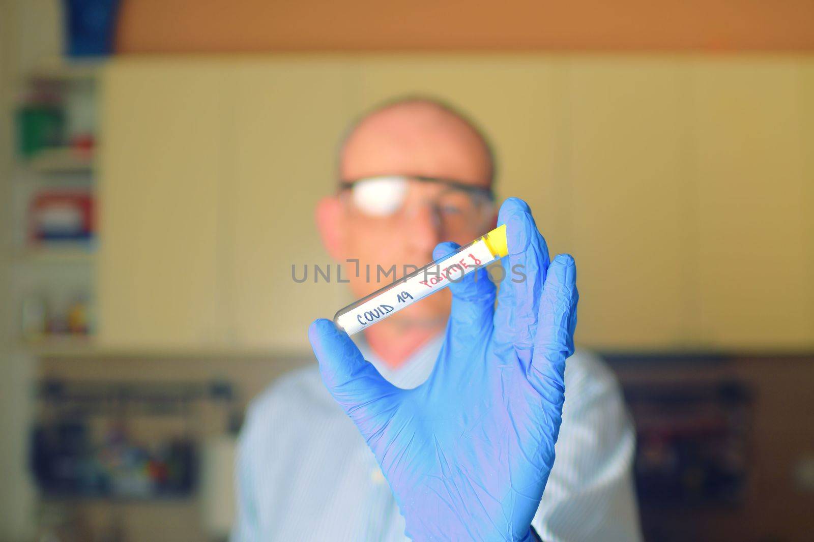 The sample of Covid 19 in the test tube. Doctor - epidemiologist holding thesample tube with sample of coronavirus. by roman_nerud