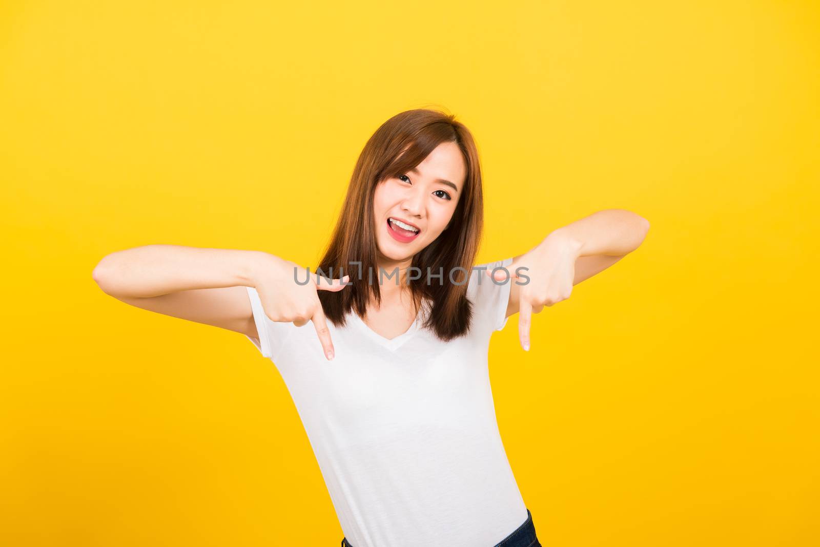 woman teen standing makes gesture two fingers point below by Sorapop