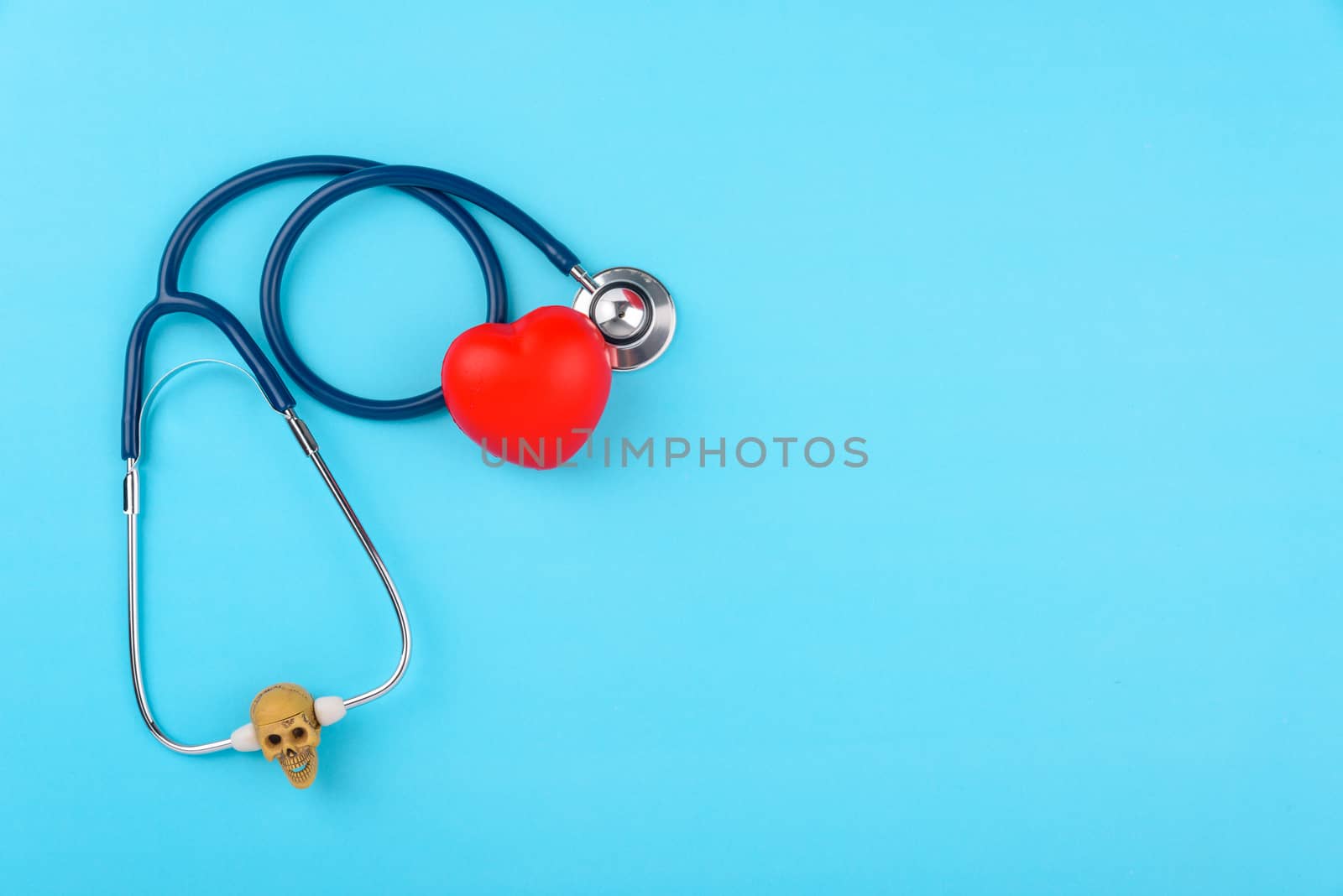 Doctor's Day concept, flat lay top view, stethoscope with red hearts diagnosis of heart disease on blue background with copy space for text