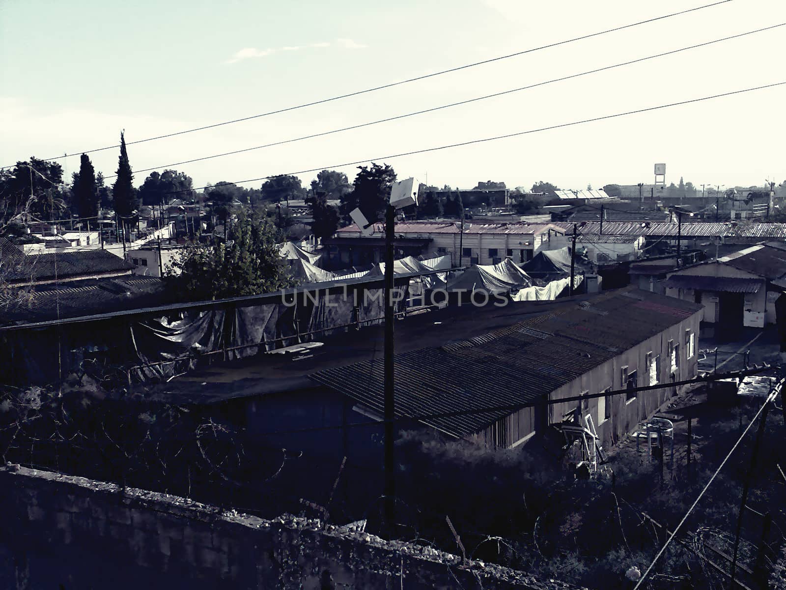 A view of an old and abandoned prison base. It also looks like a factory area. Dark mood concept.