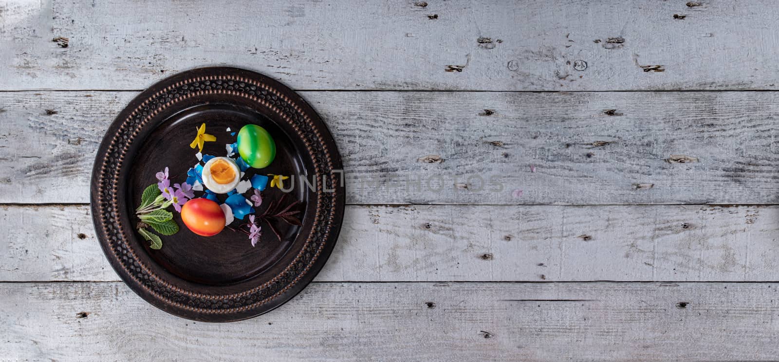colored easter egg on wood background by PeterHofstetter