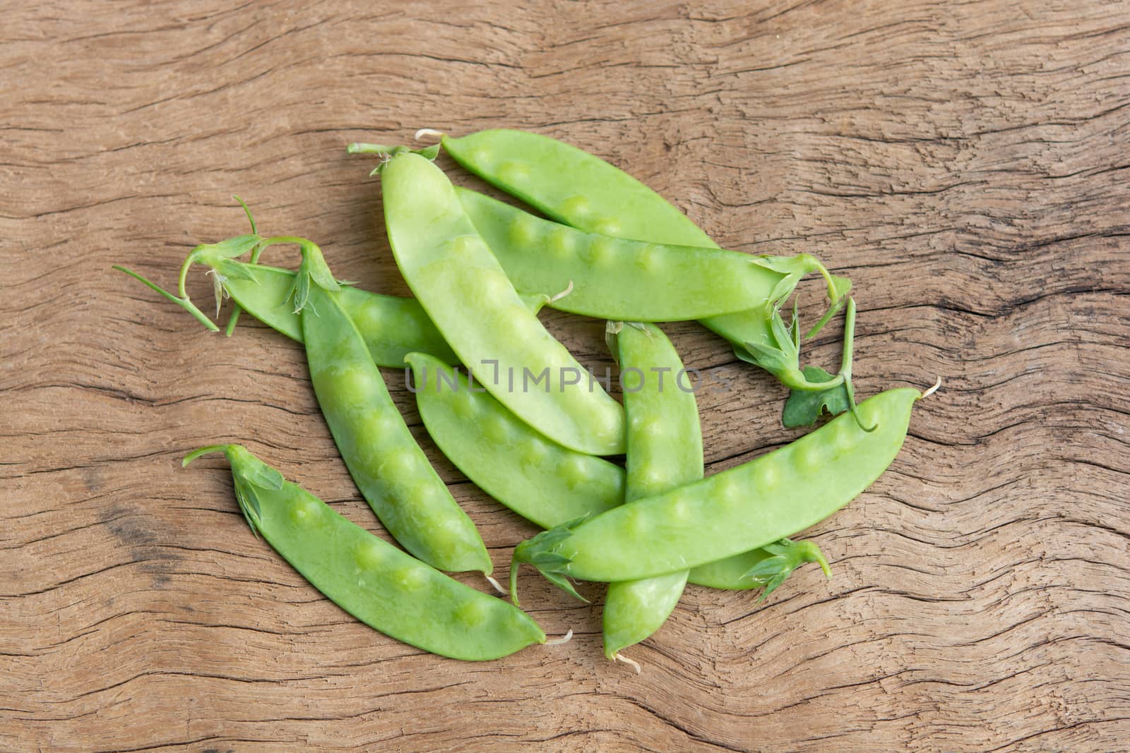 Sugar Pea, Snow peas on plank wooden background