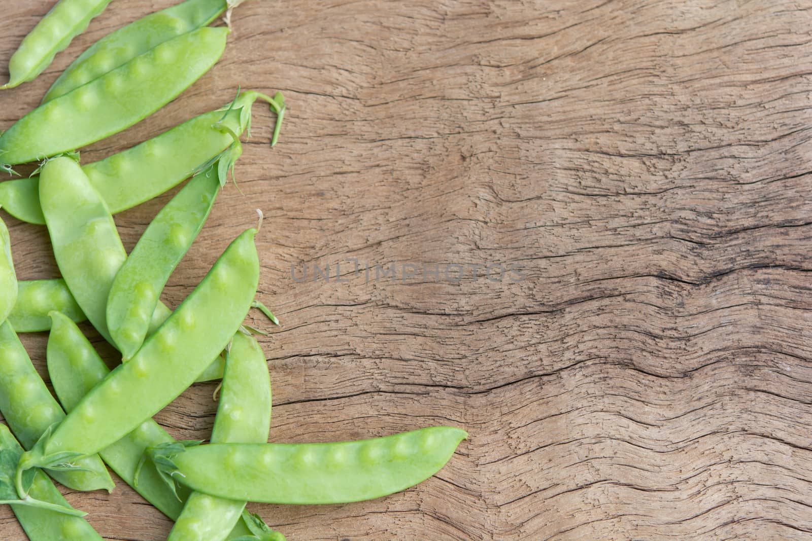 Sugar Pea, Snow peas on plank wooden background