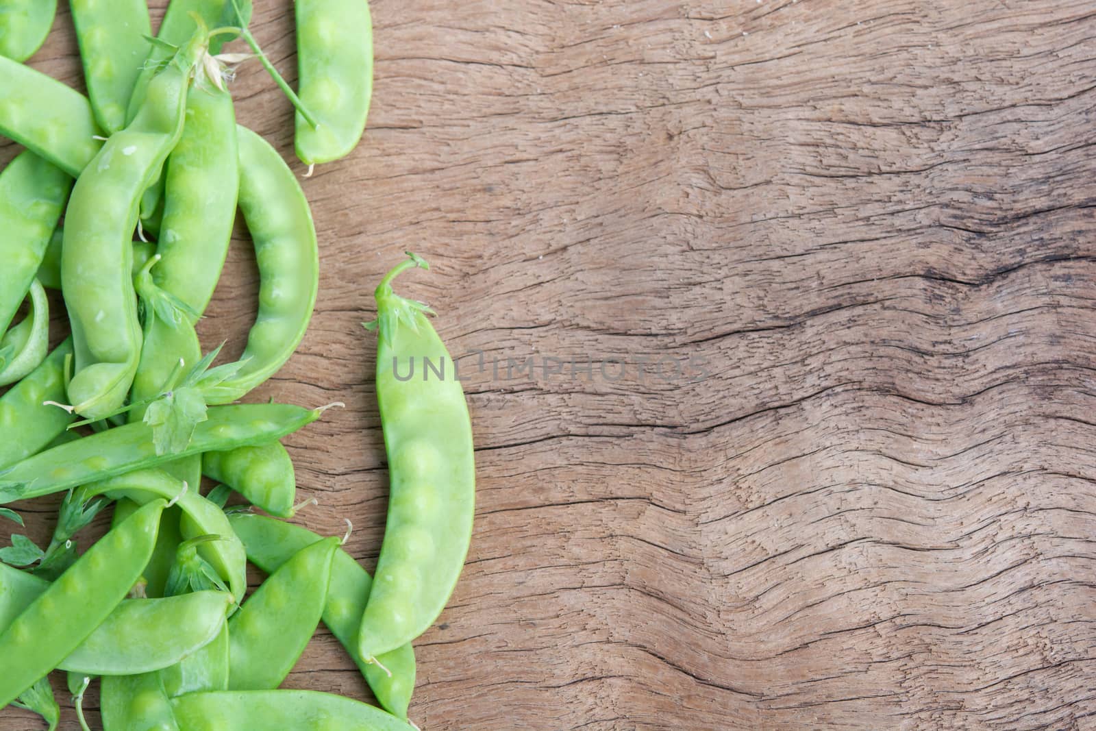Sugar Pea, Snow peas on plank wooden background