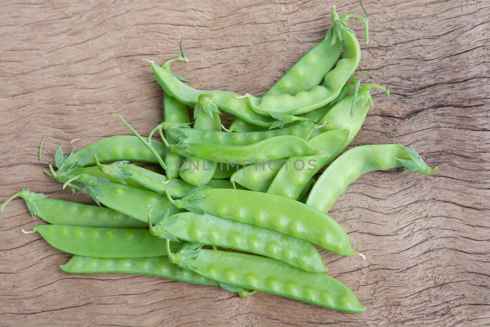 Sugar Pea, Snow peas on plank wooden background
